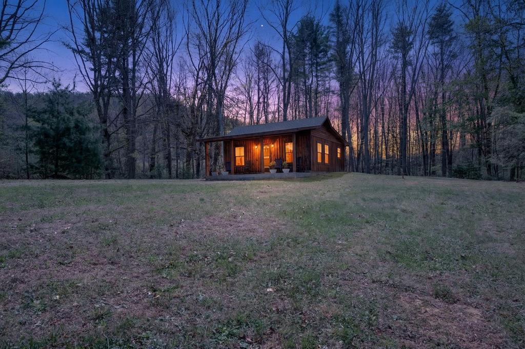 Tucked away on 2 secluded acres at the corner of Thomas Heights and Spring Hollow Rd, this beautifully crafted 2025-built home offers the perfect blend of modern design and peaceful country surroundings. Surrounded by nature and filled with the soothing sounds of the outdoors, this cozy yet stylish retreat provides privacy while still being just a short drive from town. Inside, you'll find a thoughtfully designed space featuring beautiful wood accents throughout and impressive 13-foot ceilings that create an open, airy feel. The home blends modern style with warm, natural finishes, giving it a unique character that feels both contemporary and inviting. The exterior showcases attractive wood finishes that complement the natural landscape and enhance the home's charm. This 1-bedroom, 1-bath home is being sold fully furnished, with all furniture conveying, making it truly move-in ready or an excellent turnkey opportunity for a personal retreat or investment. Enjoy mornings and evenings surrounded by nature, with abundant wildlife and peaceful country views all around. If you're looking for a stylish, newer home that offers privacy, comfort, and a connection to nature—while still being conveniently close to town—this beautifully designed property is one you won't want to miss.