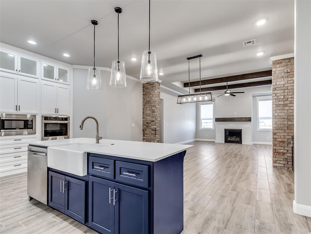 Welcome to this move-in ready, beautifully maintained home in the sought-after Creekside at Cross Timbers community in Edmond. This modern and stylish property features an open, spacious floor plan and designer finishes throughout. The gourmet kitchen showcases floor-to-ceiling custom cabinetry with glass inserts, quartz countertops, stainless steel Samsung appliances—including double ovens and a decorative vent hood—and a large center island perfect for entertaining. The home boasts 8-foot doors throughout, elevating the sense of space and luxury. Enjoy custom HUNTER DOUGLAS window treatments, many of which are equipped with smart automation, including the primary bedroom’s blackout/privacy feature. The oversized primary suite includes gorgeous exposed ceiling beams, a spa-like bath with a freestanding tub, large walk-in shower, and a closet that conveniently connects directly to the laundry room. Additional features include a SAFE ROOM in the garage, a SMARK SPRINKLER SYSTEM that adjusts based on weather conditions, and a transferrable structural warranty for added peace of mind. Relax and unwind while taking in stunning Oklahoma sunsets from your covered back patio. The HOA offers extensive lawn and landscape care, including mowing, edging, weed control, shrub maintenance, seasonal plantings, and even holiday decor—perfect for those with busy lifestyles. Community perks include social events like Ladies Night and Mahjong Night, and you’re just minutes from I-35, providing quick access to all that Edmond and the OKC metro have to offer. Don’t miss this exceptional opportunity to own a well-cared-for home in one of Edmond’s premier communities!