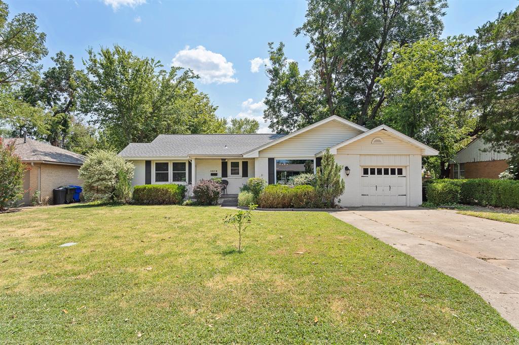 Massive price adjustment! Location, location, location! This updated campus-area charmer is move-in ready and packed with personality. Featuring 3 spacious bedrooms, 2 full baths, and two living areas, the flexible floor plan offers plenty of room to spread out. Gorgeous wood floors flow through much of the home, while the updated kitchen features refreshed cabinetry and countertops, newer stainless steel appliances, and a large island with bar seating. The second living area offers a cozy fireplace and barn doors, making it perfect as a game room, home office, or additional living space. Updated lighting and hardware throughout add a fresh touch. Outside, enjoy a large backyard with patio, plus a one-car garage. New windows throughout! Great location, great updates, and ready for its next owner!