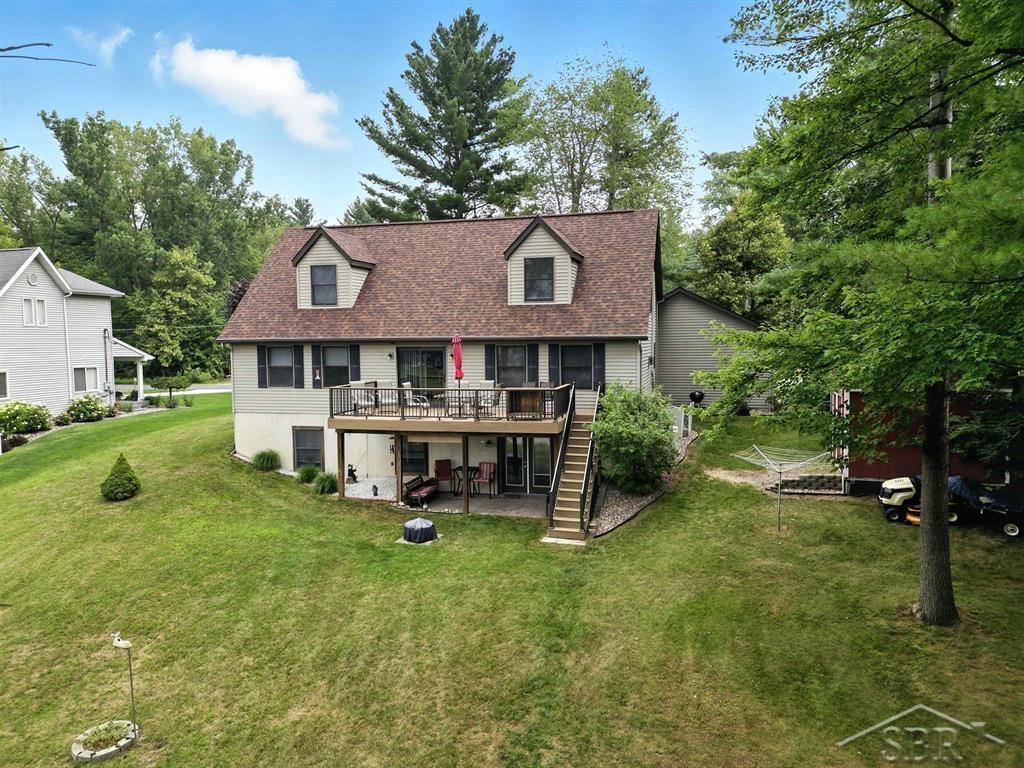 COMFORTABLE LAKE LIVING ON CLARENCE COURT! Welcome to your lakeside retreat on the shores of the soon to be returning Sanford Lake! This well-maintained 3-bedroom, 2.5-bathroom,  2- story house has so much to offer! Step inside to a bright and inviting living room featuring a cozy fireplace, perfect for cool evenings. The open layout flows into the kitchen which features a large island  and dining area, offering easy access to a spacious deck overlooking the water where the entire shoreline was recently re-done! . The upstairs offers generous sized bedrooms and a full bathroom. The walk-out basement boasts generous 9 foot tall ceilings with endless opportunities to create your own space! The basement walk out opens to a nice cement patio area and backyard with plenty of room for entertaining. Enjoy nights around the fire pit or relax in the shade with a view of the water. There's also a large shed for your outdoor gear and tools, and a dependable Generac generator to keep things running no matter the weather.  Recent updates include: new drain field, roof, water heater and deck. The home also has city water and natural gas. Please refer to FLTF for updates and assessment details. This is your chance to enjoy lake life year-round. Don't miss out, schedule your private showing today!