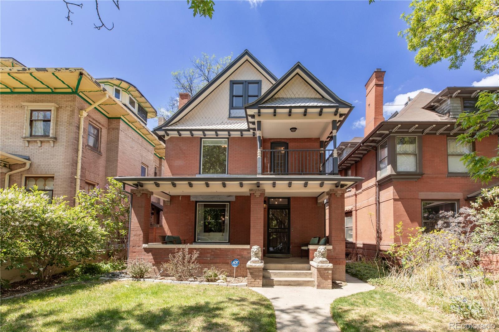 Located on a charming tree-lined street in the heart of Congress Park, 1361 Elizabeth Street is an exceptionally spacious and beautifully updated Denver classic that blends historic character with modern comfort. From the moment you step into the welcoming foyer, you’ll notice the rich wood trim, soaring ceilings, and generously sized rooms that create a warm, inviting atmosphere. Beyond the formal living and dining rooms, the home opens to a spacious great room filled with natural light, complete with an eating area and seamless connection to the kitchen. The kitchen offers ample counter space and cabinetry, ideal for everyday living and entertaining. Upstairs, the expansive primary suite features a walk-in closet, while two additional bedrooms provide excellent flexibility, including one oversized room with its own balcony and fireplace. A large loft offers exceptional versatility and can easily support multiple uses including a home office, fitness area, playroom, or creative space. Outdoor living is just as inviting, with a covered front porch, private balcony, and secluded back patio surrounded by professionally landscaped, low-maintenance grounds. Just blocks from City Park, East High School, 12th Avenue shops and restaurants, the Botanic Gardens, Cheesman Park, the Denver Zoo, and the Museum of Nature & Science, the location offers outstanding access to central Denver. Major updates include electrical and plumbing updates in 2001, dual furnaces and central A/C in 2018, tuckpointed chimneys in 2017, an impact-resistant roof in 2022, a new water heater in 2025, abundant basement storage, and a two-car garage with a brand-new garage door. A rare combination of size, updates, character, and location in one of Denver’s most beloved neighborhoods.