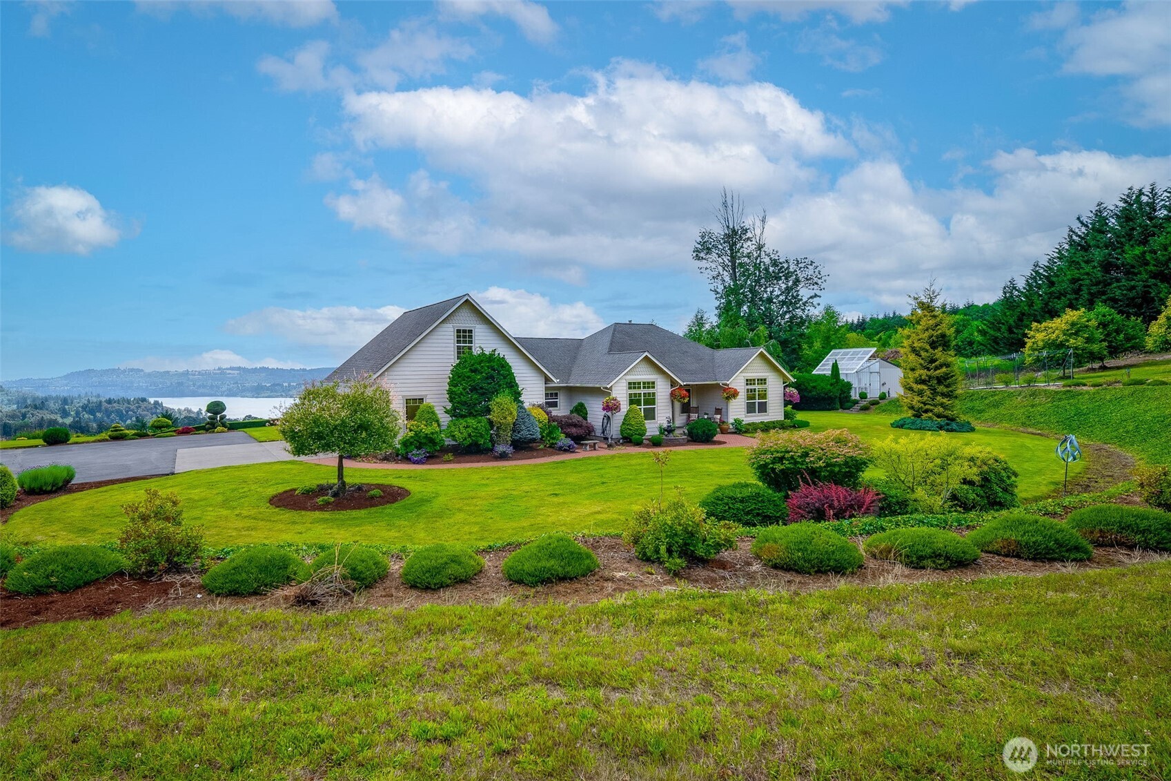 A rare opportunity to own an impeccably maintained custom home on 7+/- acres. Approximately 2+/- acres of beautiful landscaping around the home offers breathtaking panoramic views of Lake Mayfield and the surrounding valley. Designed for refined private country living, this exceptional property features a fully automated irrigation system, established orchard, automated greenhouse, and expansive outdoor living spaces, including a covered patio with skylights, retractable awning, and spectacular lake views. The heated shop with septic connection, RV/boat lean-to, and unfinished upper level offers outstanding potential for an ADU, guest suite, or home office. Inside, quality craftsmanship shines with granite countertops, solid-core hardwood doors, vaulted ceilings, abundant natural light, brand-new kitchen appliances, a luxurious primary suite with lake-view soaking tub, and a spacious bonus room with ¾ bath. Recent updates include exterior paint, heat pump, furnace fan, and professionally seal-coated driveway. Privacy, elegance, and versatility combine to create an extraordinary Pacific Northwest retreat.