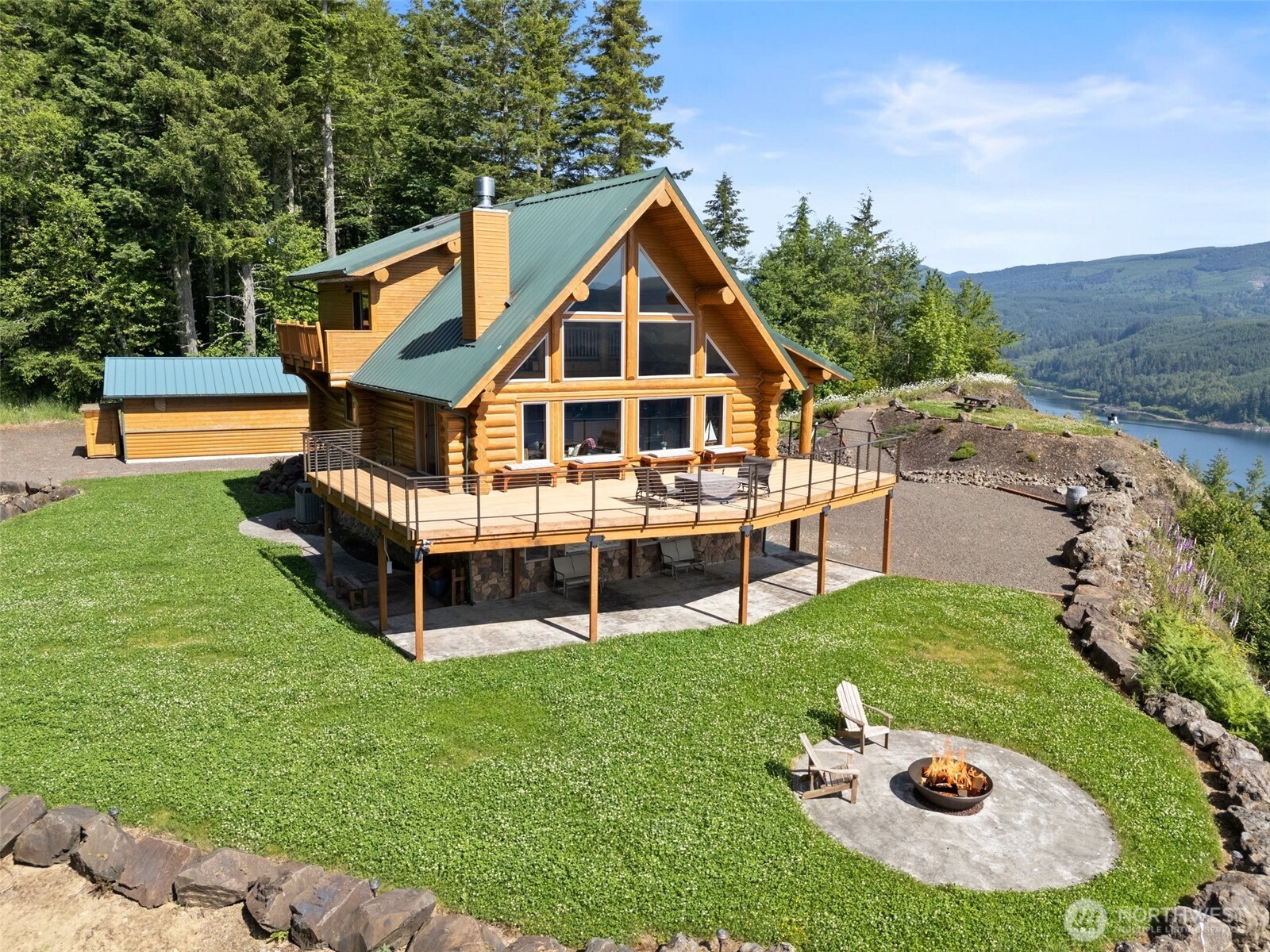 Escape to tranquility in this stunning lakefront home, boasting breathtaking views of Riffe Lake. 3 beds, 2.5 baths home features lofted primary suite w/panoramic lake views, open-concept living w/floor-to-ceiling windows, & elegant Italian stone accents on the basement exterior & main-floor fireplace. Enjoy outdoor on the expansive wrap-around Trex deck. Beautiful kitchen w/knotty pine cabinets & granite tile ctrs, lower-level rec rm w/ample storage. Additional features include a 24x36 Shop/Garage & RV Parking, provides plenty of space for hobbies & outdoor enthusiasts. Nestled in a gated community w/5 miles of lake frontage, this private oasis offers peaceful surroundings & a stress-relieving retreat from hustle & bustle of daily life.