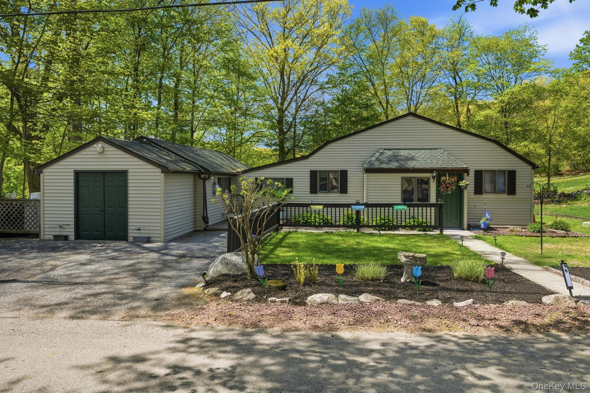 Tucked into a single-family community on Peach Lake, this updated three-bedroom one-level bungalow sits on a double lot overlooking Pehquenakonck Country Club golf course in North Salem. Peach Lake is one of the few local lakes where motor boats are welcome and summer feels a little longer. Stunning gardens lead you home. Inside, bright, spacious rooms balance everyday ease with room to gather. The spacious entry with closet opens to Living Room which flows into a Family Room that could easily flex as a home office or fitness space. The Primary Bedroom and Second Bedroom are just off the family room. Primary offers a dressing area with closets and a full tiled bath with new vanity, Second includes its own sitting room, and Third Bedroom is privately set toward the front of the home. The dine-in Kitchen has been fully renovated (2022) to offer stainless steel appliances, generous counter space and a propane stove. Luxury vinyl flooring throughout most of home. Second full bath with spa tub and new vanity is located off hallway with generous closet spaces. Laundry Room and Mechanicals are on same level. Dryer and Hot Water Heater 2022. Out back, a huge deck opens to level land made for long summer days, plus two storage sheds. Beyond the front door: a beach, dock, playground, and fireworks over the lake are just moments away. Private well, propane heat, public sewer.