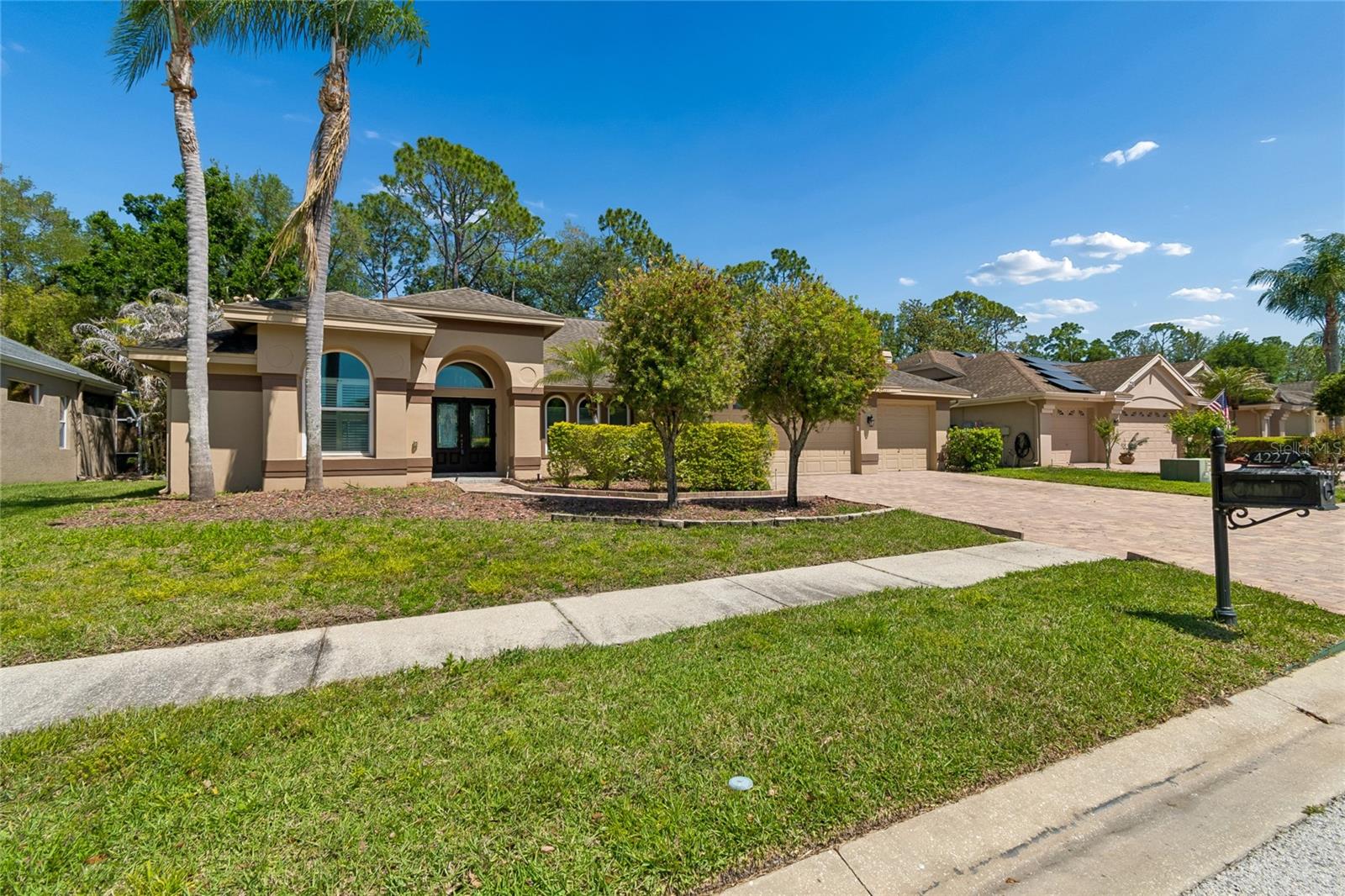 Welcome to this exceptional executive home in the highly sought-after Lansbrook community, ideally located along the desirable East Lake corridor of Palm Harbor. This beautifully crafted Marc Rutenberg residence offers 4 spacious bedrooms, 3 full bathrooms, and a 3-car garage across 2,244 square feet of thoughtfully designed living space.At the heart of the home, the expansive kitchen is perfect for both everyday living and entertaining, featuring quartz countertops, a center island, built-in desk, and abundant counter and cabinet space. The adjoining family and living rooms are filled with natural light and enhanced by a cozy fireplace, while sliding glass doors create a seamless transition to the screened pool and lanai—perfect for embracing Florida’s indoor-outdoor lifestyle.The primary suite serves as a private retreat, complete with a generous closet and a well-appointed ensuite bath featuring dual vanities, a soaking tub, separate shower, and private water closet.Notable updates include a 2020 roof, 2021 HVAC system, 2019 hurricane impact windows, a new pool pump, and a 2020 water heater. Additional highlights include soaring 11-foot ceilings, updated flooring throughout, and plantation shutters that add both style and privacy. Located in an “X” flood zone, this home does not require flood insurance, providing added peace of mind.Residents of Lansbrook enjoy an exceptional array of amenities, including a private boat ramp with access to Lake Tarpon, a waterfront pavilion, volleyball courts, sports fields, playgrounds, and miles of scenic walking and biking paths. The Pinellas Trail is just minutes away, along with convenient access to golf, fitness centers, medical facilities, shopping, dining, and parks.Zoned for top-rated schools—Cypress Woods Elementary, Tarpon Springs Middle, and East Lake High—this home truly offers the perfect blend of comfort, convenience, and community.Schedule your private showing today and discover the Lansbrook lifestyle.