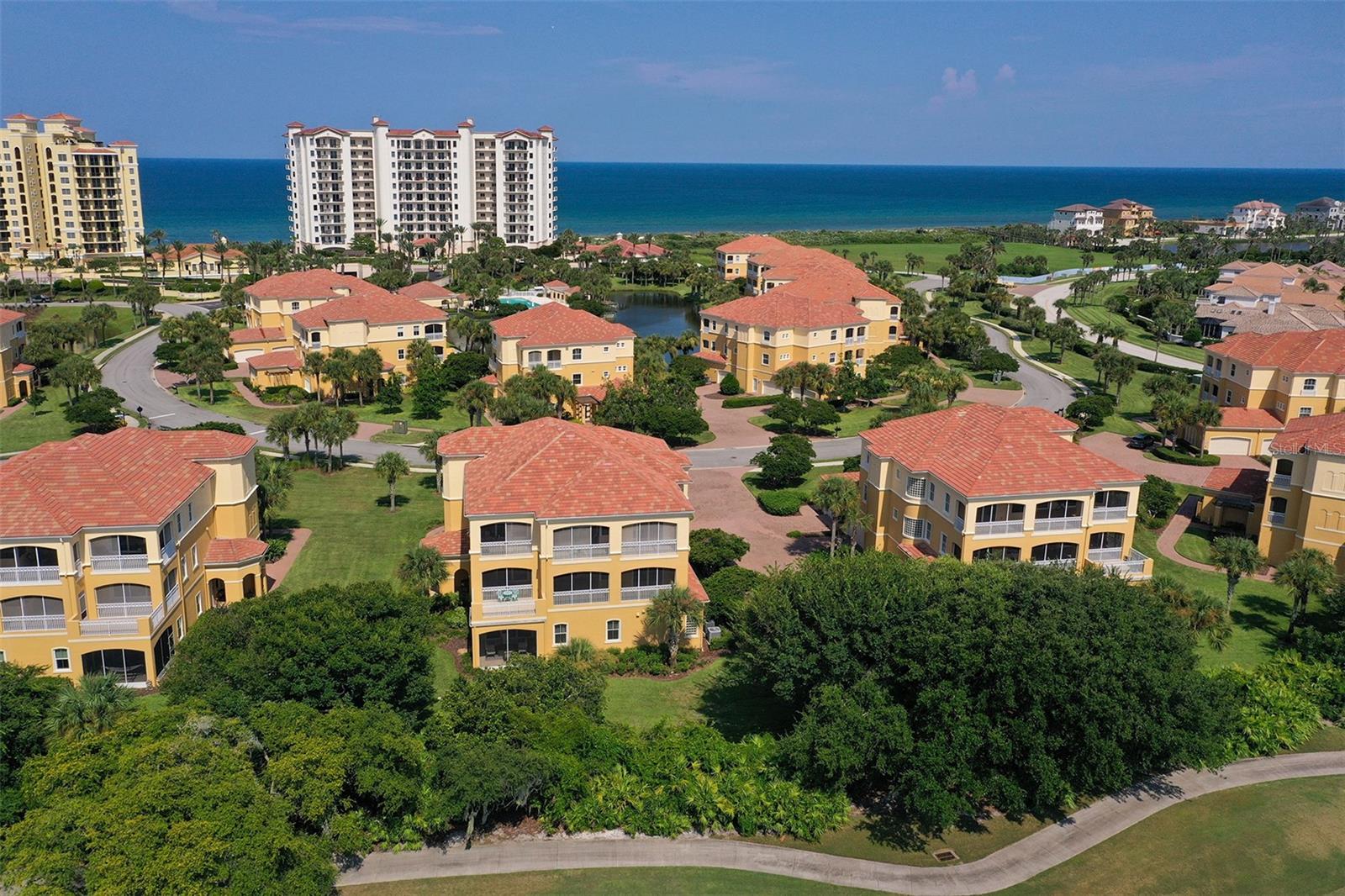 Live Your Best Life in Casa Bella at Hammock Dunes.This first-floor residence is among the rarest in Casa Bella, offering a private entrance and a sprawling screened lanai overlooking fairway greenery on the Tom Fazio championship golf course.The foyer features decorative columns, coffered ceiling detail, and a statement light fixture. The open living area is filled with natural light from oversized sliding glass doors that lead directly to the lanai and golf course views beyond. Crown molding runs throughout the home, complemented by warm neutral tones and deliberate, high-end finishes in every room.The kitchen is a defining feature of the residence. Exotic rainforest green granite covers the island, perimeter counters, and backsplash in one continuous, uninterrupted surface. Rich maple cabinetry surrounds a full stainless steel appliance suite, and artisan pendant lighting hangs above the island. A pass-through window connects the kitchen to the tray-ceilinged formal dining room.The primary suite offers direct lanai access, dual walk-in closets, and a spa-inspired bath with dual vessel sinks, a deep soaking tub framed by glass block windows, and a separate rainfall shower. Two additional guest bedrooms, a distinctively designed powder room, a dedicated laundry room, and a two-car garage with epoxy flooring and built-in cabinetry complete the floor plan. The home is impeccably maintained throughout.Community and location:Casa Bella is set within the gated, 997-acre enclave of Hammock Dunes, directly along the Tom Fazio championship golf course and near the Atlantic Ocean. The community consists of 19 Mediterranean-style carriage home buildings, each with only one residence per floor. Residents have access to a community pool pavilion, Jacuzzi, and fitness center. Optional membership to the Hammock Dunes Club is available at closing, granting access to two championship golf courses, tennis, bocce, oceanfront dining, and a fitness facility.This first-floor, single-story residence with private entrance and golf course frontage is a rare offering within Casa Bella.