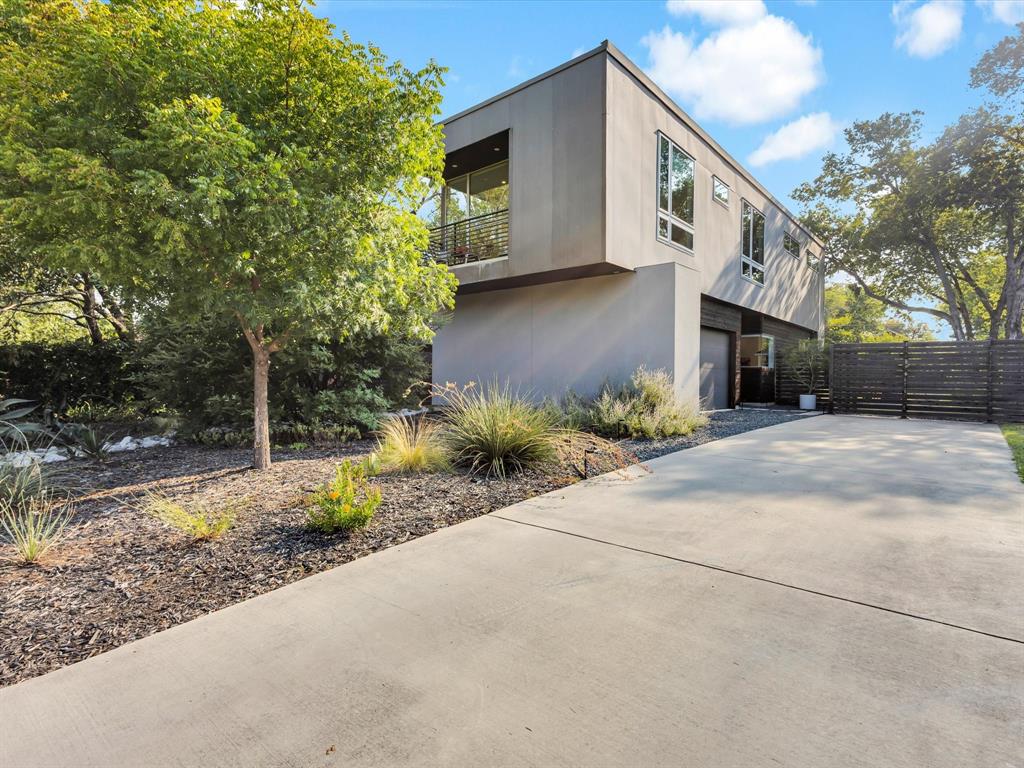 Welcome to 2837 College Avenue—a striking architect-designed custom home in the heart of Fort Worth. Celebrated for its clean lines and thoughtful design, this modern residence was proudly featured on the 2021 AIA Fort Worth Tour of Homes.  The home makes a statement before you even step inside, with a professionally landscaped, drought-resistant front yard that offers both beauty and sustainability. Out back, you’ll find an expansive garden area complete with mature fruit trees—perfect for those who love outdoor living, gardening, or simply enjoying nature in their own backyard.
Inside, the home is defined by a minimalist aesthetic with sleek polished concrete floors downstairs and hard wood upstairs. A ductless heating and cooling system and tankless water heater provide efficiency and comfort year-round, while oversized, energy efficient windows invite in abundant natural light.  The home also features a standing seam metal roof, the ultimate material for hail resistance.  At the heart of the home sits a true chef’s kitchen, with high-end appliances, custom cabinetry, and quartz countertops designed for both everyday living and entertaining. The living spaces are open and versatile, blending modern design with a warm, inviting atmosphere.
Upstairs, the bedrooms are generously sized, each offering huge, energy efficient windows, wood flooring, with two bedrooms having access to private patios—a rare touch that makes every room feel like a retreat. The third bedroom offers flexibility to serve as an office, or second living space depending on your needs.  An oversized garage ensures there’s plenty of space not only for vehicles but also for storage, hobbies, or even a workshop.  Located in Fort Worth’s Near Southside, this home places you just a short drive or bike ride away from the vibrant energy of Magnolia Avenue, South Main Street, and the many restaurants, and entertainment venues that make this neighborhood one of the city’s most desirable areas.