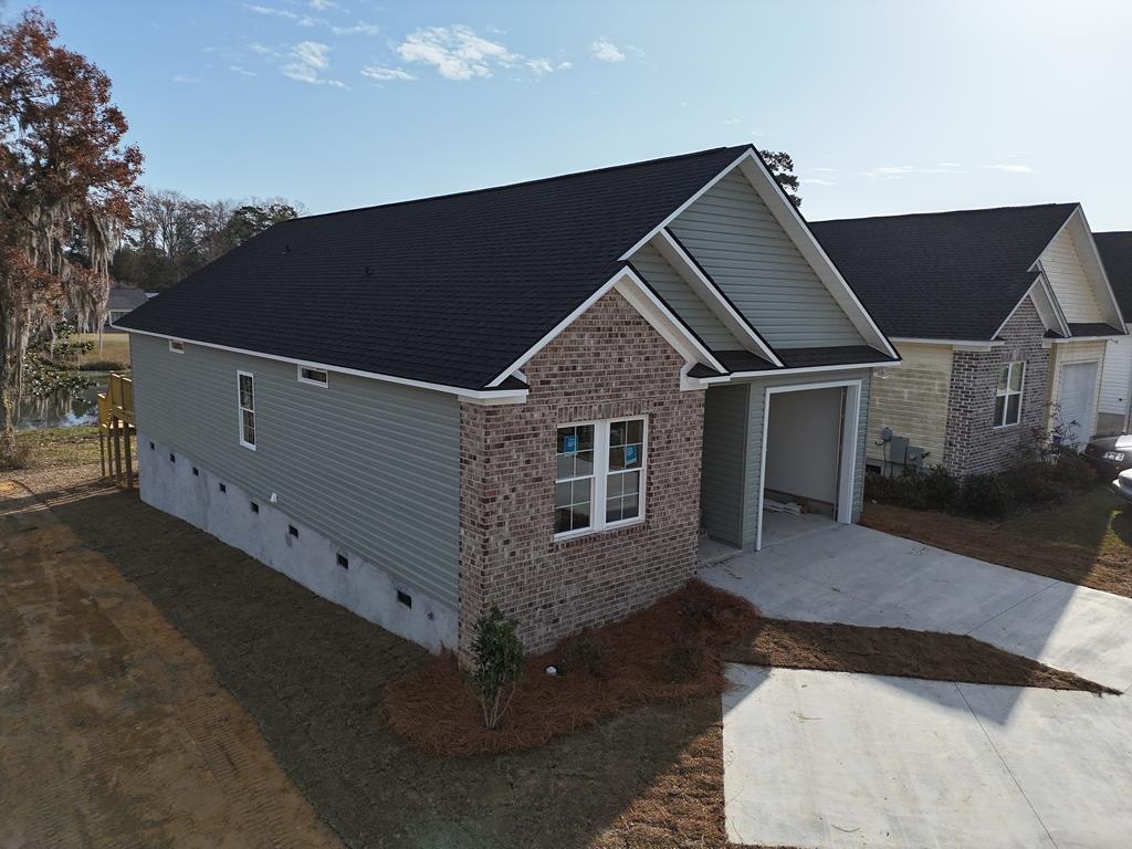 Sit on your covered back porch with adjoining wood deck and watch the fish jump and the ducks glide in the lovely Lake. Spacious single family cottage home in the desirable 55 and older Huntington Pointe Subdivision. 3 bedrooms and two baths with an enormous great room with vaulted ceiling and spacious bar separating the large kitchen filled with cabinets. Garage for safety and privacy. Under deck and house is storage and beautiful landscape outside. Lots of quality extras inside this soon to be completed new construction home. Many want this quiet area but desire a single family home, here it is! Completion date expected October 2025