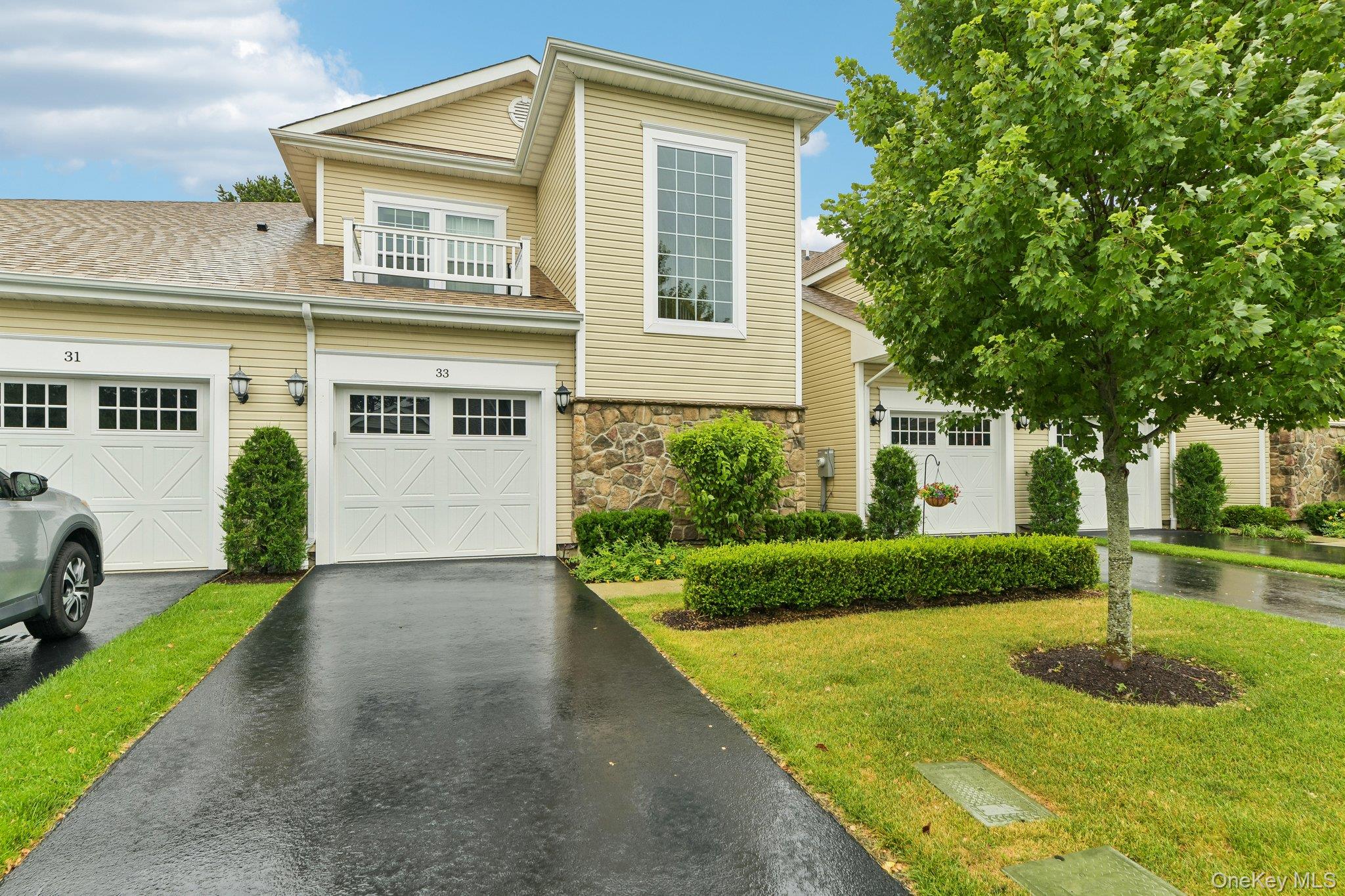 Welcome to 33 Greentree Court, a beautifully appointed second-floor condominium in a desirable gated 55+ community offering the perfect blend of comfort, convenience, and low-maintenance living. This recently constructed home features 2 spacious bedrooms, 2 full bathrooms, a versatile bonus room, cathedral height ceilings, and an eat-in kitchen overlooking the covered terrace, perfect for enjoying your morning coffee or unwinding at the end of the day. Enjoy the convenience of an attached garage, private in-unit elevator, and in-unit laundry.Whether you’re looking to embrace a more leisurely lifestyle or need a home that accommodates an active work schedule, this residence offers modern amenities designed for ease and comfort. Residents enjoy a vibrant clubhouse with social events, a swimming pool, hot tub, bocce courts, and scenic walking trails. Ideally located near major roadways, transportation, shopping, the East End, Patriots Preserve, and Smith Point County Park, this is an exceptional opportunity to enjoy the best of Long Island living.
