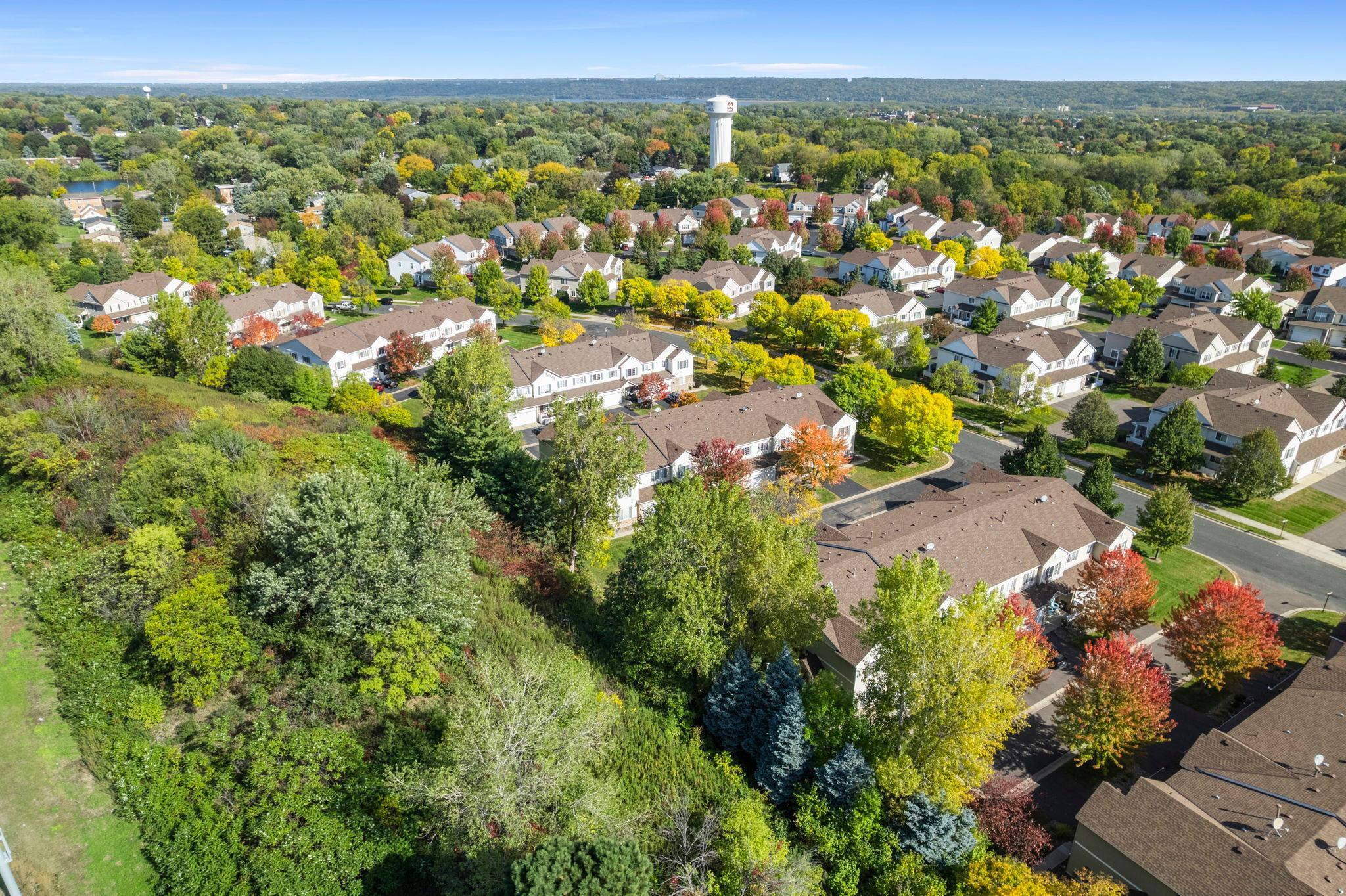 Beautifully maintained 2-bedroom, 2-bathroom end-unit townhome in a peaceful Inver Grove Heights neighborhood, just steps from scenic ponds, parks, and Southview Country Club, with easy access to major roadways for a seamless commute.The inviting main level features 9-foot ceilings and abundant natural light, creating a bright, welcoming atmosphere. The cozy living room offers plush carpeting and a Heat-N-Glo fireplace, perfect for relaxing or entertaining. The open-concept layout flows into the dining area with statement lighting and a stylish kitchen complete with stainless steel appliances, under-cabinet lighting, a two-tier peninsula with breakfast bar seating, and a walk-in pantry. A powder room, spacious closet, and attached 2-car garage add everyday convenience.Upstairs, a versatile loft provides ideal space for a home office, media room, or additional living area. Two generously sized bedrooms include ceiling fans, with the primary offering a large walk-in closet. The oversized full bath features both a walk-in shower and tub/shower combination. Upper-level laundry adds ease to everyday routines. Enjoy a private front patio and serene surroundings!