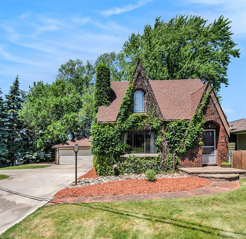 This Tudor-style waterfront retreat on all-sports Lake Fenton offers timeless charm and serene lakefront living with 45 feet of frontage on an expansive double lot. A graceful wrap-around driveway sets the tone, welcoming you to a home that blends character with comfort. Inside, you’ll find 3 nice-sized bedrooms and 2 thoughtfully designed baths, including an updated main bathroom with modern finishes. Newer windows frame breathtaking lake views and invite natural light to pour into every room, creating a warm and airy ambiance throughout. Step outside to enjoy your morning coffee or host unforgettable gatherings on the lakeside deck. The 2022 dock is ready for boats, paddle boards, or soaking in sunset views. Whether you’re embracing summer on the water or enjoying the peaceful setting year-round, this home is made for lake life. With charming architectural details, great outdoor space, and on desirable Lake Fenton, this is your chance to own a piece of Fenton's popular waterfront.
