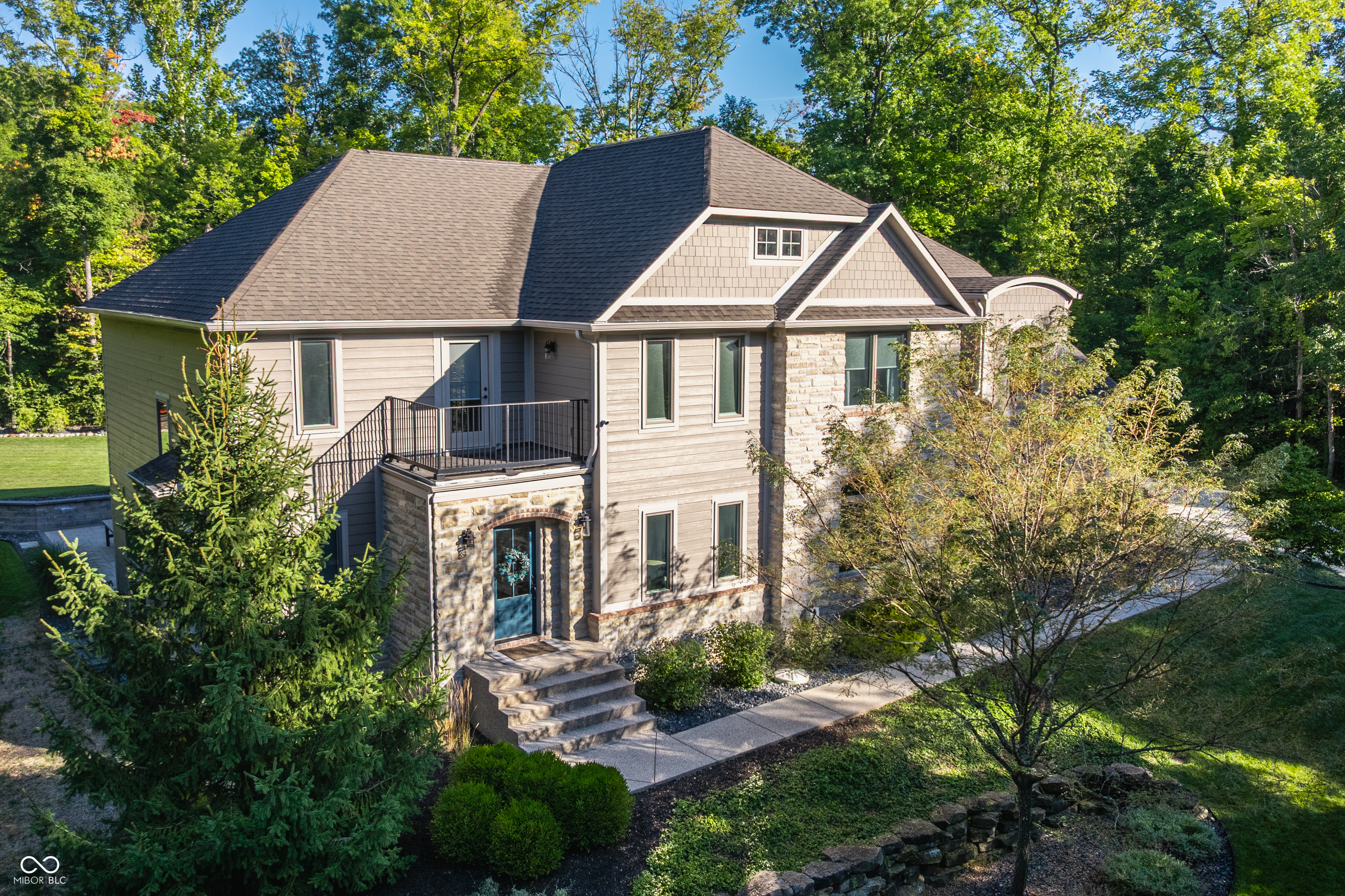 Welcome to 9358 Sullivan Place, an exceptional home nestled on 0.92 acres of serene, wooded privacy. This beautifully updated property offers the perfect blend of comfort, space, and upgrades-making it truly move-in ready. Step inside to find a main-level primary suite, main-level laundry, and an additional flexible room ideal for a home office or easily converted into a fifth bedroom. The open layout is bright and inviting, with fresh paint, new windows, new flooring and carpet, and thoughtful finishes throughout. The views from the back of the home are remarkable-tucked away on a cleared, private lot featuring a brand-new patio perfect for relaxing or entertaining. The walk-out unfinished basement offers endless potential to create the custom retreat of your dreams. Upstairs, you'll find a spacious bonus/playroom and three additional bedrooms-two with private ensuites. A third full bath is conveniently located near the third bedroom, along with a cozy nook perfect for reading, studying, or gaming. With a new flooring, driveway, modern updates throughout, and incredible outdoor space, this home has it all. Don't miss your chance to own this stunning, private retreat on Sullivan Place!