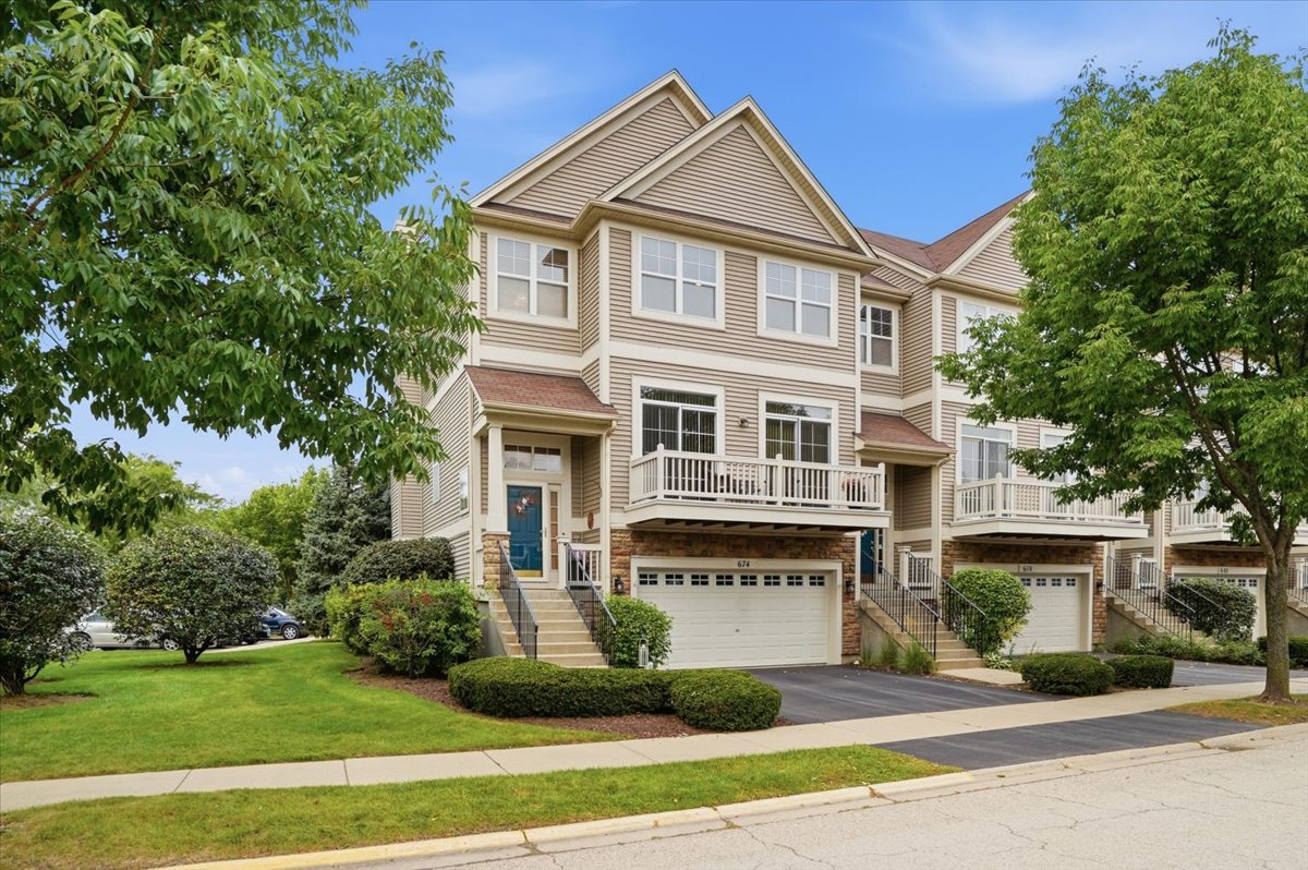 Welcome to the highly sought-after Cambridge at Waters Edge community, just steps from beautiful Gages Lake! This spacious end-unit townhome offers 3 bedrooms, 3.5 bathrooms, and flexible living space across three levels. Enjoy multiple outdoor spaces, including an east-facing balcony off the living room, a west-facing balcony connected to the breakfast nook, and a private patio accessible from the lower level. Upstairs, you'll find two spacious en-suite bedrooms and a conveniently located washer and dryer. The lower level features an additional bedroom and full bathroom, making it ideal for guests, a home office, or a private living area.  Recent updates include a NEW furnace and A/C in 2024, plus NEW refrigerator, oven, microwave, and dishwasher in 2022. Cambridge at Waters Edge offers resort-style amenities, including lake access with a private beach, private launch, pier, gazebo, and walking path. Best of all, this home includes its own designated BOAT SLIP on Gages Lake! Don't miss this rare opportunity to enjoy lake living at its best.