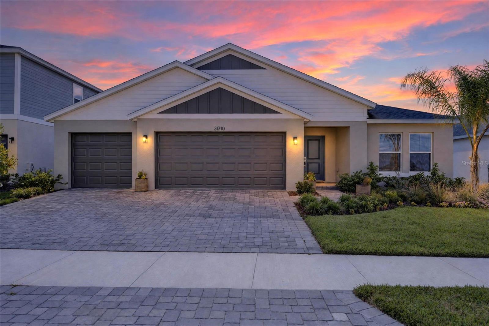 Rare opportunity in Pasadena Landing with a potentially ASSUMABLE MORTGAGE at 5.25%—subject to lender approval and buyer qualification! Buyers may also receive a FREE APPRAISAL when using the seller’s preferred lender. This impressive Jazmin floorplan offers 5 bedrooms, 3 full baths, a bonus room, and a 3-car garage, all on a quiet cul-de-sac in Wesley Chapel with NO CDD fees and just steps away from the community pool, playground, and other amenities!Designed with both style and function in mind, the open-concept kitchen features quartz countertops, stainless-steel appliances, 42” upper cabinets, a large pantry, and an upgraded tile backsplash. The spacious owner’s suite offers an oversized walk-in closet, double vanity, and walk-in shower with floor-to-ceiling tile. A private in-law/guest suite adds flexibility for multigenerational living or visitors, while the bonus room and additional flex space provide even more options for a home office, playroom, or media room.The sellers have invested over $15,000 in additional upgrades, including a Maytag whole-home water filtration and softener system, fully fenced backyard, upgraded oil-rubbed bronze Schlage door hardware, upgraded cabinet hardware, ceiling fans, additional bathroom hardware, fresh paint, and a 240V/30-amp garage connection.Enjoy the covered lanai and fenced backyard, plus the convenience of a 3-car garage and transferable builder warranties for added peace of mind.Pasadena Landing also offers a community pool, dog park, and tot lot. Beyond the neighborhood, you’re close to KRATE at the Grove for local dining, events, and entertainment, Tampa Premium Outlets for shopping, and both Epperson Lagoon and Mirada Lagoon for some of the area’s most unique resort-style recreation.If you’re looking for newer construction without the CDD, extensive upgrades already completed, flexible living space, and the added benefit of a 5.25% assumable mortgage opportunity, this home deserves a closer look.