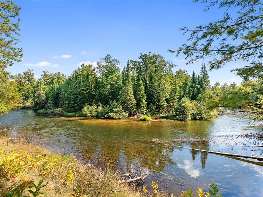 This extraordinary 20-acre estate encompasses the legendary DevilÃ¢â‚¬â„¢s Elbow of the Au Sable River, one of Northern MichiganÃ¢â‚¬â„¢s most storied and scenic bends. With more than 1,500 feet of frontage wrapping both sides of the river, the property delivers unparalleled privacy, protected panoramic views, and a palpable energy from the riverÃ¢â‚¬â„¢s dramatic bend and swift current. From the elevated homesite, the views are exceptionalÃ¢â‚¬"sweeping both up and downstream and centered on a private island that is part of the property. On the far bank, an additional acre of deeded land lies surrounded by 30,000 acres of protected State Forest, ensuring unmatched seclusion and adventure. The existing home has been taken to the studs, offering a rare opportunity to restore or create a new architectural statement. Electric, well, and septic are on site (condition unknown). Multiple build sites and potential splits provide endless possibilities for a family compound, retreat, or legacy holding. World-class fly fishing, abundant wildlife, and year-round outdoor recreation, this is a once-in-a-lifetime offering worthy of the finest portfolios.