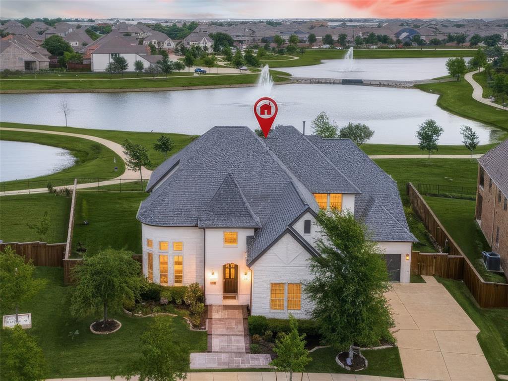 Experience the perfect harmony of luxury & innovation in this meticulously maintained home. Every detail of this 4,575-square foot home has been curated for comfort, security,& high end entertainment, situated on a premium 0.31 acre interior lot you will enjoy spectacular unobstructed views of two lakes, & beautiful Texas Sunsets. A comprehensive ADT provided security system, including 24 7 camera surveillance with DVR recording for continuous monitoring. This smart home is Alexa-Managed Lighting Fully integrated smart lighting, chandeliers, & decorative lighting, Smart Climate Control Thermostat, Smart locks on front & backyard entries & Smart GDO. Gladiator Storage system installed in both garages. Tesla charger in single garage. Gourmet Kitchen features Sub-Zero refrigerator, gas cooktop, gas DBL oven, kitchen island, pantry, & vented exhaust fan. Plumbed for ice maker and gas. Smart Media Room- $30,000 custom cinema suite with professional-grade sound, Apple TV, & Xbox One. Family Room features vaulted ceilings, a stone fireplace gas logs & starter, wood flooring & remote shades. Huge Primary Suite with large windows faces lake views & the moon visits at night.  Ensuite with two separate vanities, his & her closets, soaking tub & shower.  The backyard is a pleasant retreat featuring four fruit-bearing trees, Apple, Plum, Pear, Persimmon & rose bushes, yard is private and fenced. Custom Iron door with dog door insert. Spacious covered patio wraps around the back of the house offering plenty of room to dine and enjoy views with family and friends. This thoughtfully designed floor plan also offers a front and back staircase, perfect for children to come in and run up back stair case to their space with ensuite bedrms, GRM & Media Rm. World Class community offers jogging, hike & bike trails, pool, park & playground. Highly rated public schools are minutes away for grades kindergarten through high school.