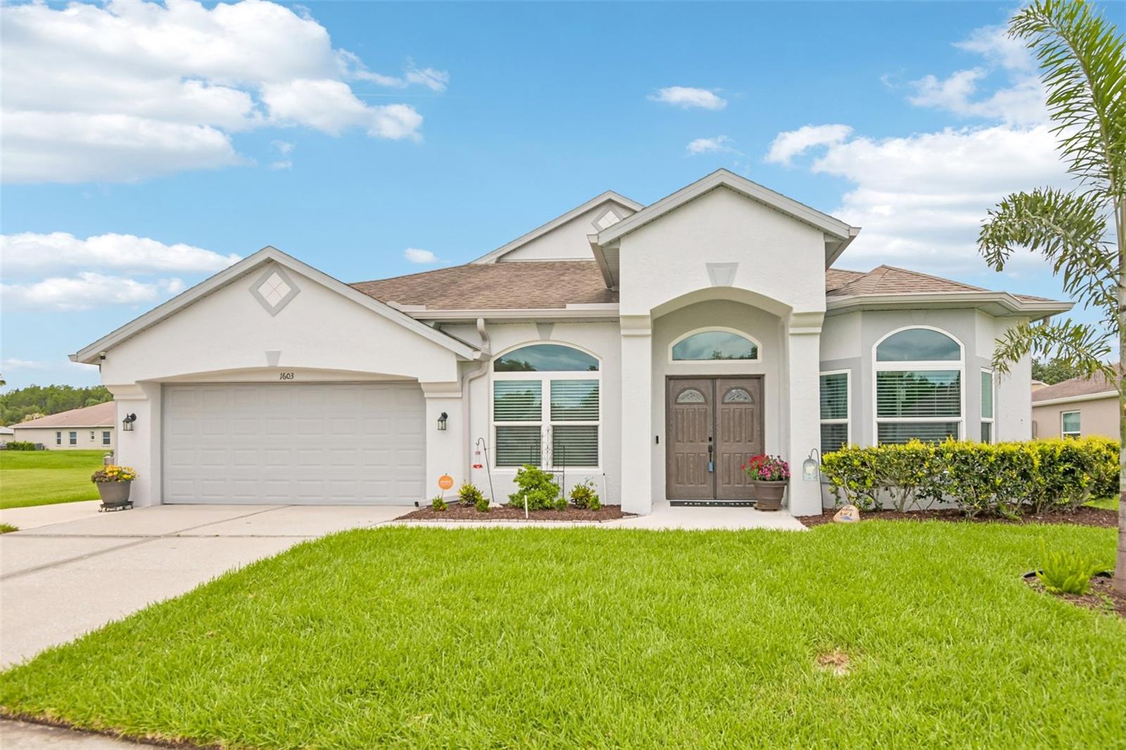 Under contract-accepting backup offers. Come on in! Located in the highly sought-after Meadow Pointe community, this beautifully maintained, move-in-ready single-family home features an open-concept, split-floorplan layout with 3 bedrooms plus a flexible office or play space highlighted by large arched windows and French doors. Boasting over $100,000 in major capital upgrades over the past 5 years—including recently painted exterior, new front doors, a new HVAC system with updated ductwork, energy-efficient windows, and a handicap-accessible wraparound sidewalk leading to a covered, screened- in lanai for a weather free protection while sipping your coffee in the am and taking in the breathtaking sunsets in the evening on the private enclosed patio. The interior seamlessly flows with easy-maintenance wood-grain tile throughout. The spacious kitchen is equipped with abundant white cabinetry, durable dark countertops, and modern stainless steel appliances, while the accommodations include a fully remodeled secondary bathroom and a generous primary suite complete with a dual-sink vanity, a large glass-enclosed shower, and a separate soaking tub. Outdoors, the property sits on an expansive lot of over 1/4 acre, featuring fresh sod, professional landscaping with a comprehensive irrigation system, a covered, screened-in lanai for weather-free relaxation, and a massive backyard that is perfect for a future pool. Offering the ultimate blend of convenience and community perks with no HOA fees, residents enjoy low CDD fees that grant access to a resort-style amenity center with pools, a splash pad, a fitness center, and sports courts just a 2-minute drive away, all while being within a very short distance to a top-rated elementary school and just minutes from Target, Publix, and the Tampa Premium Outlets.
