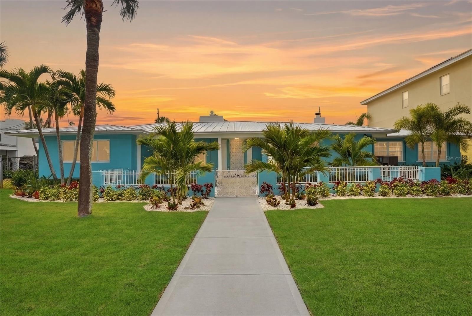 A truly rare offering in the heart of Pass-a-Grille: A generational compound that sits on an exceptionally large parcel comprised of 2 and a half lots. Positioned on luxuriously landscaped tropical grounds exceeding 0.34 acre in one of the most desirable neighborhoods on the Gulf Coast.This magnificently remodeled 3-bedroom, 3-bath residence includes a spectacular in-law suite with its own private entrance—perfect for guests or extended family.Meticulously renovated to preserve historic charm while embracing modern luxury, the home showcases a dramatic living room with soaring vaulted ceilings and a striking double-sided fireplace, creating a warm and inviting atmosphere for both relaxing and entertaining. The bright, expansive great room—with its dedicated wet bar—offers seamless additional space for gatherings and effortless hosting.The beautifully updated kitchen is spacious and functional, complemented by an oversized laundry room and room to customize to your vision. Other recent improvements include a brand-new roof, new A/C and heating systems, fully renovated bathrooms, gorgeous new flooring throughout, sidings, windows, fixtures and all-new landscaping—delivering both peace of mind and exceptional curb appeal. A two-car garage, covered porch, and extraordinary oversized yard provide ample space to design your dream pool or simply enjoy outdoor living at its finest. Just steps from the stunning sandy beach, this home is perfect for year-round Florida living or as a luxurious vacation retreat.Pass-a-Grille is widely regarded as the crown jewel of Tampa Bay's barrier island communities. Occupying the southernmost tip of St. Pete Beach on a narrow peninsula flanked by the Gulf and Boca Ciega Bay, it is one of the few remaining beach communities in Florida where condo towers are simply absent, replaced instead by historic cottages, brick-lined streets, and a walkable village centered around the storied 8th Avenue corridor. With perennially award-winning white sand beaches, boutique dining, art galleries, and a marina at your doorstep — yet just 20 minutes from the cultural epicenter of downtown St. Petersburg — it is the rare place that feels like an island out of time while offering everything a refined coastal lifestyle demands.