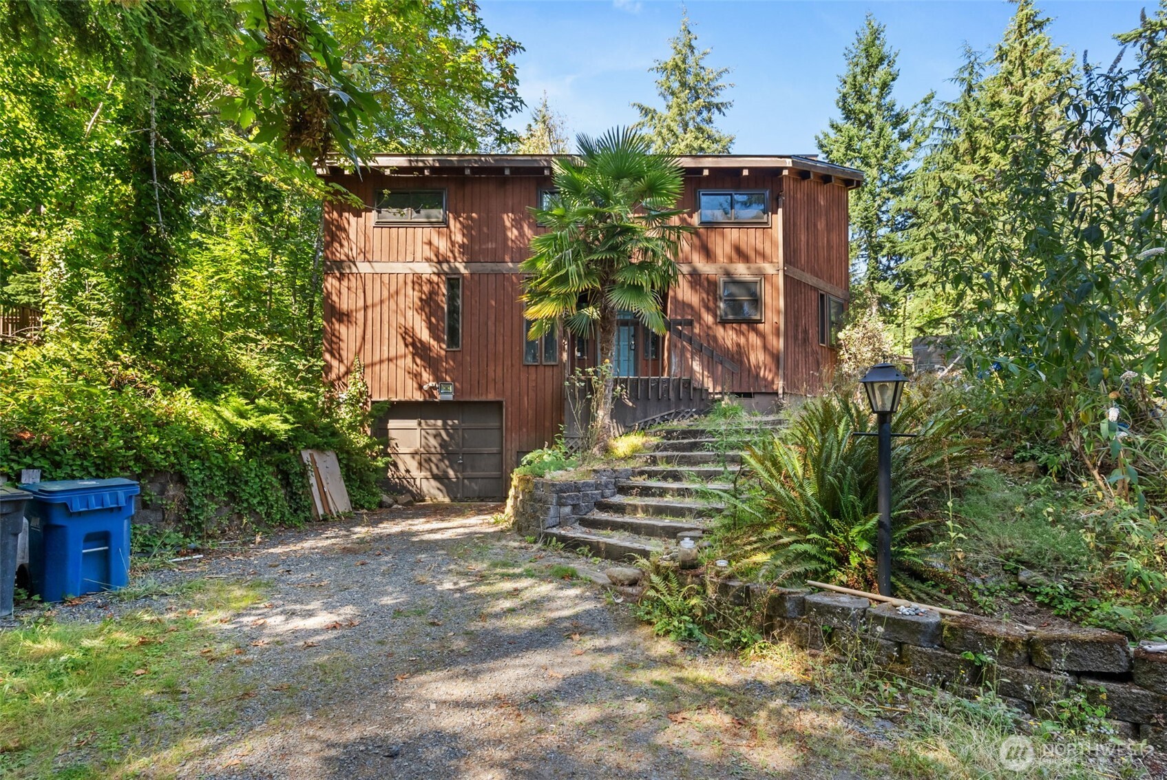 Northwest contemporary home set on a private, secluded 1.3-acre lot. Brand new roof in May 2026, new interior paint and new flooring throughout. This 3-bedroom home features soaring ceilings, dramatic two-story floor-to-ceiling windows, and an abundance of natural light with tranquil green views throughout. The main level offers a spacious primary suite with dual closets and private bath, utility room, guest half bath, and an impressive great room with vaulted ceilings and expansive windows. The kitchen flows seamlessly into the adjacent dining area, with a glass slider providing easy access to the backyard. Upstairs, two additional bedrooms, a full bath, and a versatile bonus room with loft create flexible space for guests, work, or recreation. This expansive property offers privacy, plenty of room for RV parking, and ample space to enjoy the outdoors. One car attached garage. Home needs a new septic tank and updating, a great opportunity to create a home that reflects your vision while unlocking the value and potential this property has to offer. Located in Tahoma School District. A peaceful, private setting with exceptional convenience to the area’s best recreation and amenities. Enjoy nearby lakes, scenic trails, and expansive parks, while maintaining easy access to SR-169, I-405, and I-90. Conveniently located within reach of Maple Valley, Issaquah, and Bellevue, offering the perfect blend of tranquil surroundings and commuter-friendly accessibility. Pre-inspected.
