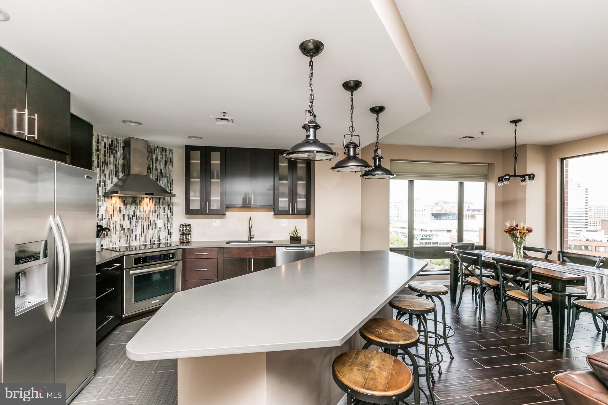 Exceptional Harbor Court condominium with Panoramic Harbor & City Views.  This fully remodeled, immaculate 1,541 square foot residence is one of Harbor Court's most beautifully updated 2 bedroom, 2 bathroom condos, offering magnificent Inner Harbor sunrises and stunning Camden Yards sunsets.The open concept living and dining area flows seamlessly to the modern chef's kitchen with quartz countertops, premium appliances, custom cabinetry and an expansive island. The spacious primary suite features a spa-style bath and walk-in closet, while the second bedroom and full bath are perfect for guests or a home office. Every detail has been thoughtfully upgraded from flooring to lighting and hardware.  The unit also has a Resideo water leak detection system which protects the unit with an automatic water turn off in the event of a leak, and also notifies the front desk. Building amenities include 24-hr front desk concierge, a deeded garage parking space, private storage, doorman services, porters secure indoor access to the Royal Sonesta Hotel's pool, fitness center available through an optional membership. Step outside to enjoy the Inner Harbor promenade, Otterbein, Federal Hill, the stadiums, restaurants, shops and easy commuter routes. Don't wait  to schedule your private tour!.