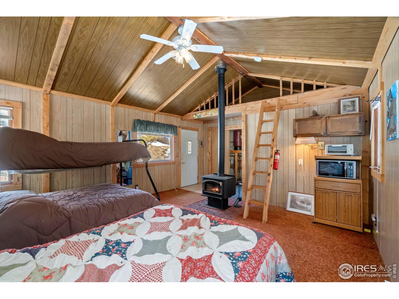 This 3-bedroom main house along with a charming guest house offers the ideal mountain escape. Freshly treated and stained house and deck, the turn-key main residence is flooded with natural light and perfect for modern living. The spacious kitchen, stocked with everything you would need, seamlessly flows into the dining and living areas. Cozy up by the fireplace or step outside to the expansive deck to savor the crisp mountain air. The guest house offers a private retreat for visitors, complete with its own amenities for comfortable living. Whether hosting friends or using it as a rental, this space provides endless possibilities. The private lake fishing membership transfers with the home, giving you access to 8 of Red Feather's private lakes for fishing and outdoor activities. Convenience is at your fingertips with an attached garage and an easily accessible mechanical room in the basement. Move-in ready, this property provides a harmonious blend of modern comforts and natural beauty, making it an idyllic haven for those seeking a tranquil lifestyle in Red Feather Lakes.