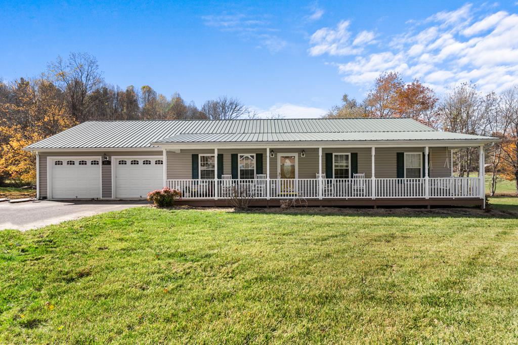 Don't miss this 3-bedroom, 2-bath home ideally located near I-77, Galax, and Hillsville! Featuring one-level living, a 2-car attached garage, hardwood floors, metal roof, and a heat pump, this property offers both comfort and lasting value. The master bedroom offers private access to its own bathroom that boasts a walk-in shower and large vanity. The covered front porch is perfect for relaxing by the sound of the nearby creek. Set on a beautiful level lot in a peaceful neighborhood, this home is a great fit for first-time buyers, investors, down sizers or anyone looking to enjoy quiet country living in a convenient location.