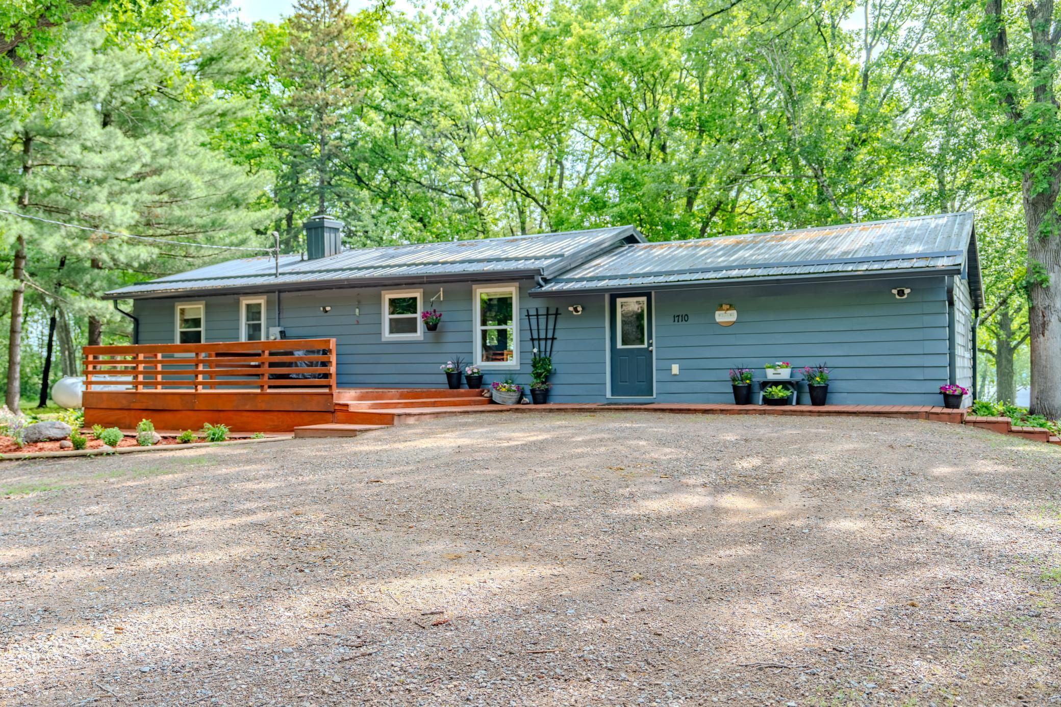 Move in ready Mississippi River retreat on 1.65 Acres that has 4 bedrooms, laundry, a bathroom plus half bath all on the main level!! Basement has tons of space for storage, hobbies & utility room!  A huge deck in the front of the home as well as deck plus patio on the river side!! Semi-open floor plan, lots of space and storage in the kitchen, newer flooring, new furnace & AC 2025, metal roof, & many extras to enjoy!  All on private setting on the edge of town - level lot and 110 feet of river frontage with Eastern views!  End of September closing date perferred.