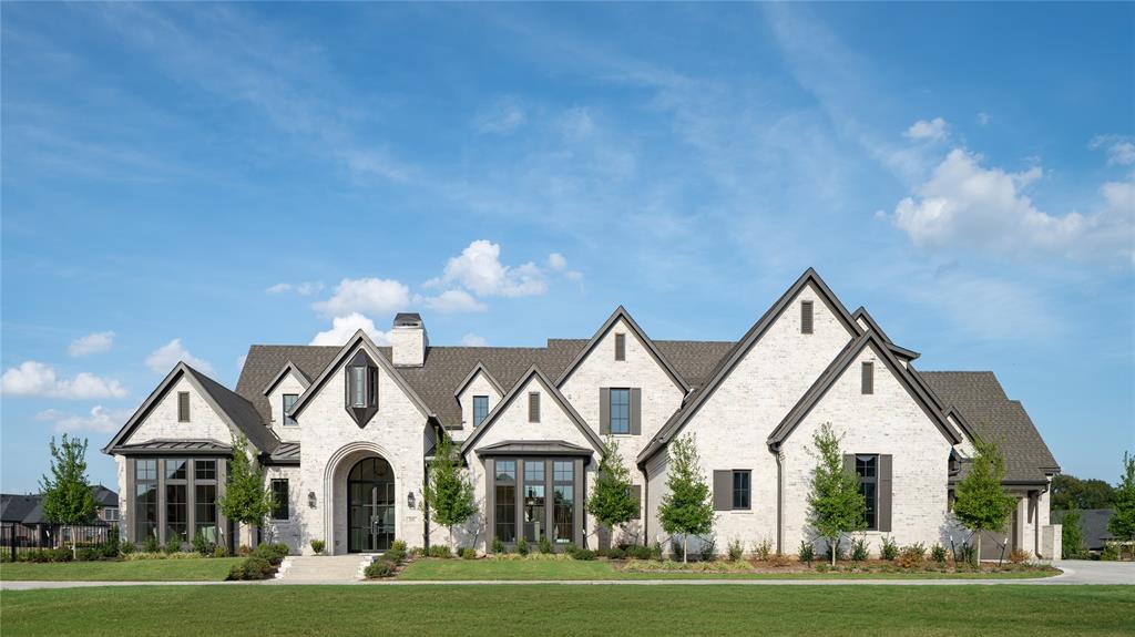 Architectural perfection meets luxury living in this custom-designed estate by New Leaf Custom Homes. The floor plan features soaring vaulted ceilings with natural wood beams, wide-plank hardwood floors, and a limestone gas fireplace. The striking window arrays are designed to maximize natural light and open airiness. The chef’s kitchen offers custom cabinetry, an oversized island with seating, a plaster range hood, and a hidden scullery. Retreat to the primary suite showcasing cathedral ceilings, a sitting alcove, and a spa-inspired bath with a freestanding tub, dual vanities, marble counters, and a boutique walk-in closet with custom island storage. Additional highlights include a study, media room, lounge, a first floor guest suite and a dramatic powder room with checkered marble floor. Step outside to an expansive covered patio featuring timber arches, a brick fireplace, and views of the manicured landscaping and pristine pool with raised spa. Modern elegance at its finest!