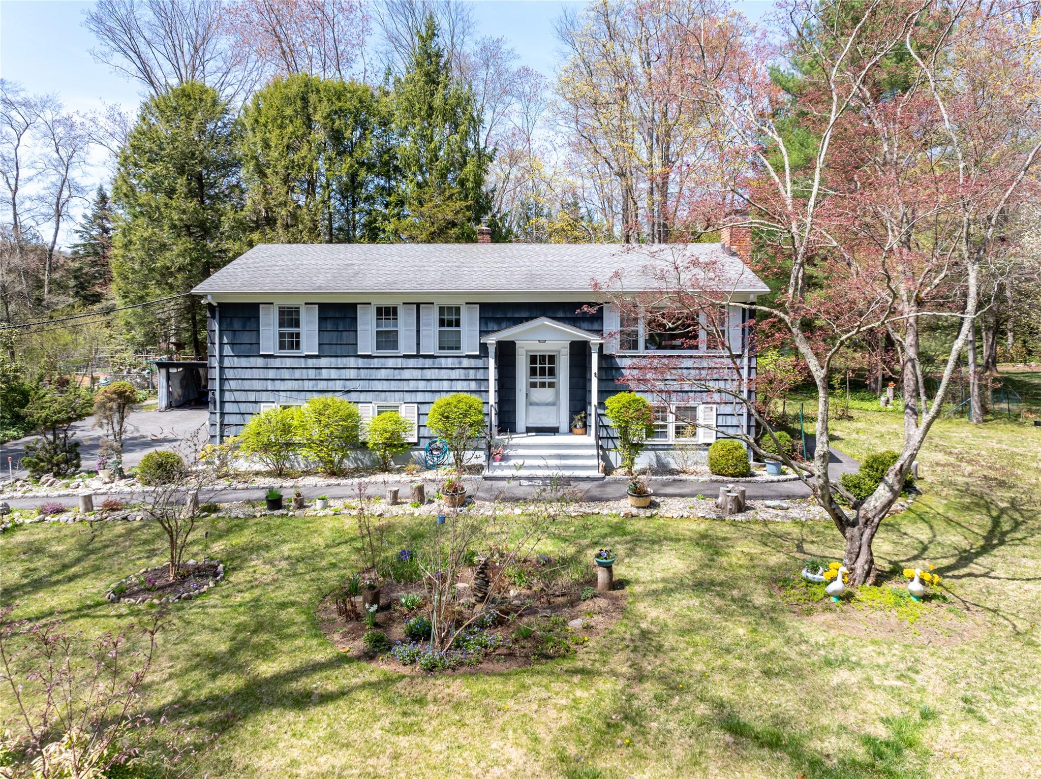 This charming, well-maintained 4 bedroom 3 bath raised ranch is a hidden gem in a highly coveted location with its unique blend of serene lake living and the conveniences to NYC, Ridgefield, Danbury & Stamford, CT. The main level features the kitchen, formal dining room & cozy living room with a fireplace and large picture window that frames the picturesque seasonal views of the lake, front yard and gardens.  Wake up to the beauty and tranquility surrounding you while you sip your morning coffee.  Down the hall finds the primary bedroom with its own full bath, two additional bedrooms and a full hall bath.  The finished lower level offers a large family room with its own fireplace as well as a bonus room which can be a guest room, craft room, study or home office etc.  Additionally, part of the lower level is sectioned and has a walk-out accessory apartment with its own kitchen, living area, bedroom, full bath and laundry area.  This unique feature gives flexibility to accommodate a variety of personal needs and purposes.  The spacious backyard has both a covered and open patio area, great for grilling, get togethers, playing sports or just relaxing while enjoying the birds and the gardens.  A short stroll around the bend brings you to the community beach where each season offers its own kind of magic. In the summer, enjoy paddle board, swimming, kayaking or canoeing across the three scenic lakes Oscaleta, Rippowam and Waccabuc. When winter arrives, sled down the beach hill, go ice skating, or try your hand at ice fishing. This warm neighborhood offers "Fire & Ice" get togethers down at the beach as well as movie nights and music on the lake.  Additionally, the Mt. Lakes Park is a mile away with hiking trails to explore and a breathtaking vista overlooking the lakes.  Don't miss this opportunity to make this exceptional home your own.  Future tax savings in 2026 of $3,200.00.