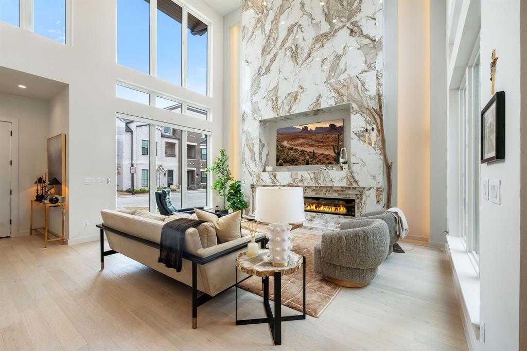 Welcome to the power move you didn't know you needed. This Perfectly positioned in the heart of Historic Downtown Oak Street, this architectural showpiece puts you steps from Roanoke's premier dining, wine bars, and entertainment yet feels like a private retreat curated for the ultra-discerning. Walk to dinner. Catch a show. Be home in minutes. And when its time to jet? DFW Airport is just a quick drive away. Lock, leave, and live large or settle in and stay awhile. This townhome is sophisticated without trying too hard. Clean lines. Thoughtful scale. Floor-to-ceiling windows flood the open-concept living space with natural light and frame serene views of your own private courtyard because yes, privacy and proximity can coexist. The first floor delivers a luxury masterclass: Expansive living area with a statement fireplace and custom built-insDesigner dining space that flows effortlessly Chefs kitchen built for both performance and aesthetics, complete with a true working pantrySpacious laundry room. Powder bath. Elevator access and floating staircase The first-floor primary suite is exactly where it should be private, sunlit, and serene. Oversized windows overlook the courtyard, creating a boutique-hotel vibe every single morning. The custom walk-in closet features built-ins and designer lighting. And the spa-inspired ensuite? Its next-level. Double vanities, elevated finishes, and a glass-enclosed wet room bathed in natural light designed to hold warmth and deliver that steam-and-reset energy without ever leaving home. Upstairs continues the flex: Spacious game room with windows overlooking the courtyard Powder bath Oversized secondary bedrooms, each with en suites Private balcony with artificial turf and built-in drainage system low maintenance esp .for the Fur Babies.  Second floor laundry room and walk in storage closet.  This home has it all...