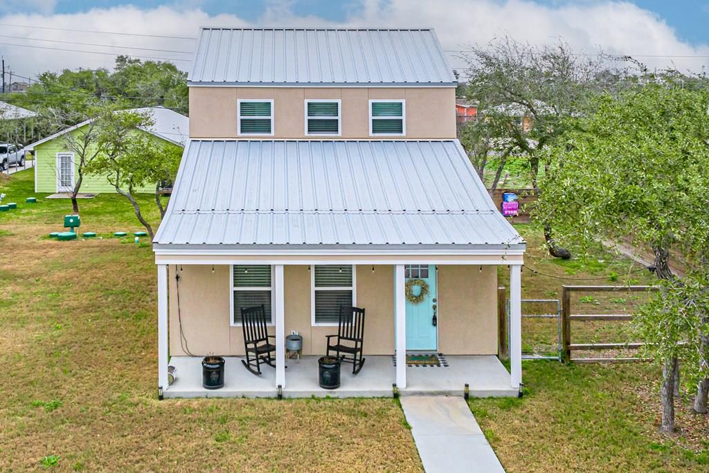 Nestled in the waterfront community of Holiday Beach, this property offers privacy, relaxing coastal living and enjoy direct access to world-class fishing, boating, dolphin watching and gorgeous sunsets. Close proximity to community amenities include 2 boat ramps, fishing pier, launching kayak park, and walking distance to community pool and community center. Located just minutes from Rockport's vibrant dining, shopping, and art scene. Most furnishings convey. Cozy covered front porch. Step inside to an inviting open-concept living space, where windows bathe the home in natural light. The cheerful kitchen boasts stainless steel appliances and granite countertops. Perfect open layout for entertaining friends and family. Main level primary suite with full bath, two closets and private entrance to the backyard. Laundry room with half bath. Two additional bedrooms plus full bath are located on the second level. Whether you're unwinding on the covered porch or hosting guests in the outdoor space, every moment here feels like a vacation.