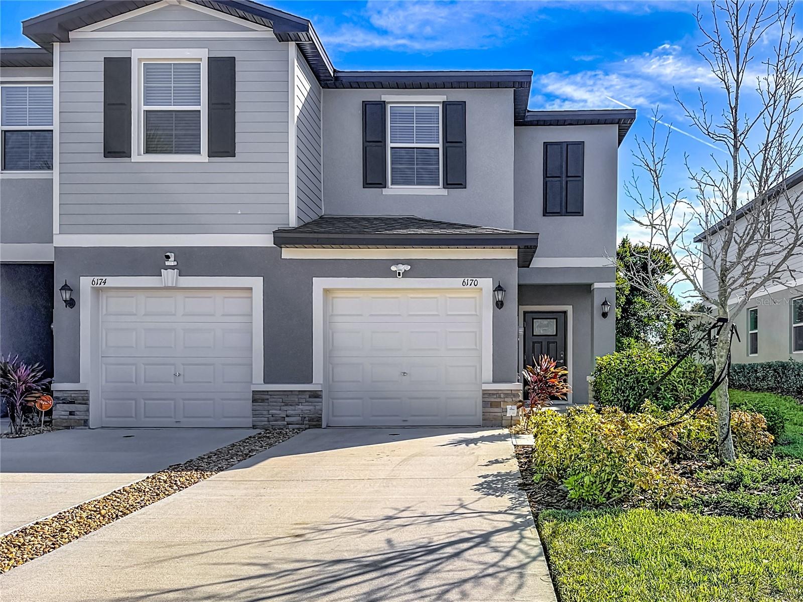 PRACTICALLY BRAND NEW-Built in 2024 and move in ready, this beautifully finished end-unit townhome has much to offer. Stop paying rent and enjoy your very own home. Featuring 2 bedrooms, 2.5 baths, and a 1-car garage, this nearly new home delivers stylish, low-maintenance living with all the benefits of modern construction. Upon entering you immediately notice the abundance of natural light that flows in and will love the open-concept layout. The kitchen is well appointed with granite countertops, white cabinetry, stainless steel appliances, and ample room for dining. Your sliding glass door leads out to the screened back patio—perfect for relaxing or entertaining. Upstairs, the spacious primary suite features dual vanities and a walk-in shower and spacious closet. The second bedroom includes its own private ensuite full bath, ideal for guests or flexible living arrangements. An upstairs laundry room adds everyday convenience.Residents enjoy access to this gated community amenities which include a community pool, dog park, sidewalks for afternoon strolls and more. One of the fastest growing areas and ideally located near Tampa Premium Outlets, AdventHealth Connerton, and the Land O’ Lakes Recreation Complex, along with easy access to shopping, dining, recreation, and major commuter routes.Enjoy low-maintenance living with LOW HOA Fees and NO CDD fees—this move-in-ready end unit offers comfort, convenience, and location all in one. CALL FOR MORE DETAILS