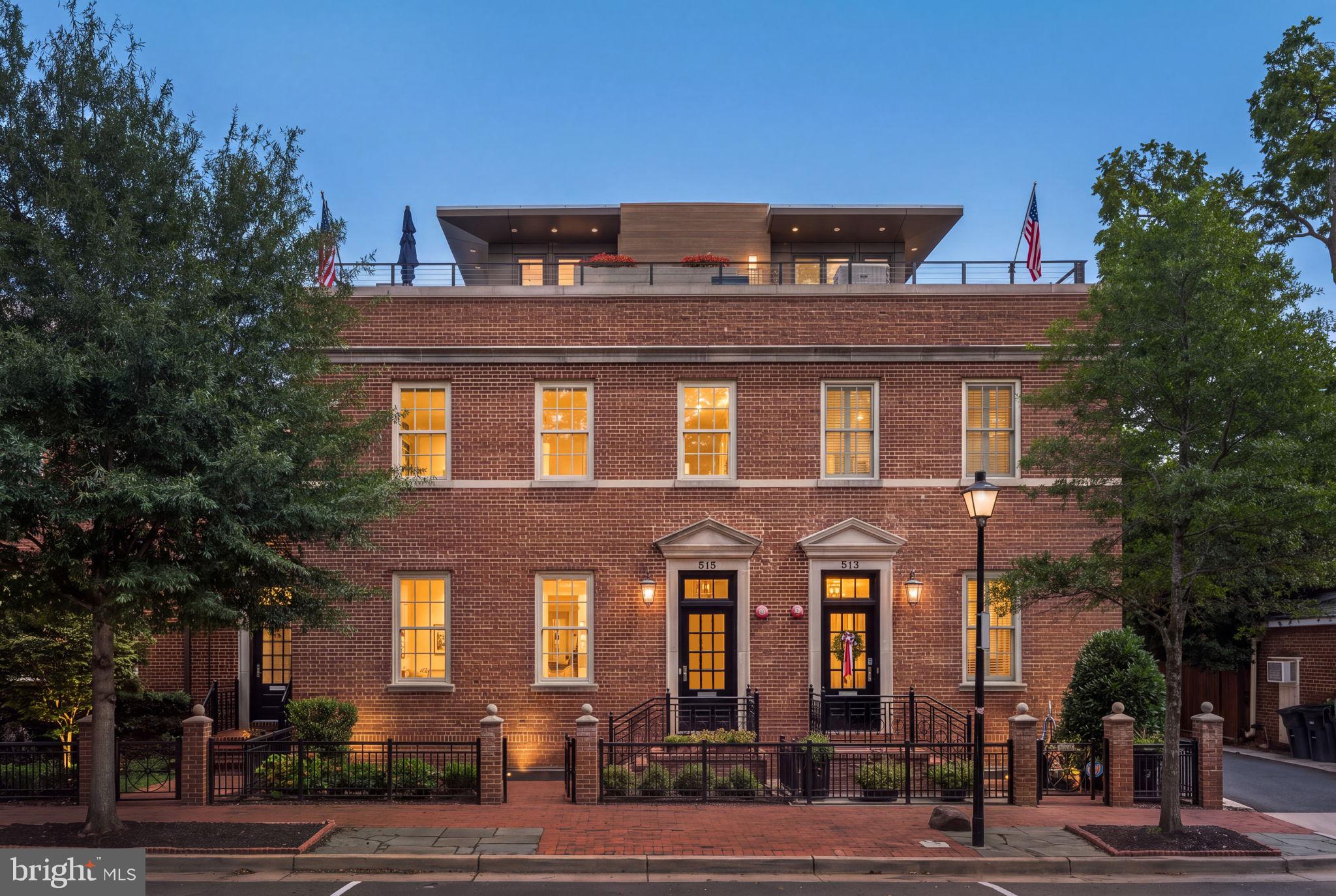 Exceptional in both design and execution, 515 North St. Asaph Street offers a rare level of luxury in the heart of Old Town. Thoughtfully appointed across four finished levels, with an elevator providing effortless access throughout, this remarkable residence offers five bedrooms, five full and three half baths, a private two-car garage, extraordinary outdoor spaces, and an exceptional degree of customization.The main level unfolds with a welcoming entry foyer and generously proportioned living and dining rooms. Beyond, the light-filled family room adjoins the kitchen, creating a wonderful sense of openness while maintaining distinct and gracious living spaces. The sophisticated kitchen is appointed with Thermador appliances, a wine refrigerator, abundant cabinetry, and an expansive peninsula with seating. Hickory hardwood floors extend throughout the main living spaces, adding warmth and character. A powder room completes this level.The family room opens to a professionally transformed private garden that is truly an extension of the home. Dedicated dining and seating areas are joined by a bocce court with runway lighting, overhead heat lamps, and landscape lighting. Direct gas lines serve the grill and fire kettle, while irrigated planters and wiring for an outdoor television add to the thoughtful functionality of the space.The primary bedroom and two additional bedrooms are located on the upper level, each with its own en suite bath. The spacious primary suite features a custom walk-in closet and a spa-like bath with a soaking tub, creating a serene private retreat. The laundry room offers extensive custom storage, while custom shades throughout the residence provide another layer of finish and privacy.The fully finished lower level offers an impressive extension of the living space, with custom built-ins, an entertainment center, and a kitchenette complete with a dishwasher and an additional refrigerator. A fourth bedroom with its own full bath provides excellent flexibility for guests, while a separate powder room adds convenience to the entertaining space.The top level is one of the home's most distinctive spaces. A sun-filled office surrounded by windows enjoys sweeping views across Old Town, while an adjoining kitchenette with a sink, dishwasher, and beverage refrigerator serves the rooftop terrace. A powder room on this level further enhances its functionality. The exquisite terrace provides generous space for dining, gathering, and relaxing, with a direct gas line for a grill and built-in planters thoughtfully surrounding the mechanical equipment.The home's fifth bedroom is a private guest suite above the garage. Complete with its own full bath and separate from the main residence, it offers wonderfully private accommodations for guests or extended stays. Below, the two-car garage includes custom shelving and valuable additional storage, a particularly coveted amenity in the heart of Old Town.From its gracious interiors and five en suite bedrooms to its elevator, two-car garage, and two spectacular outdoor living spaces, 515 North St. Asaph Street has been designed with uncommon attention to detail. Sophisticated yet exceptionally livable, it offers a remarkable combination of space, privacy, and luxury in one of Old Town Alexandria's most desirable settings.