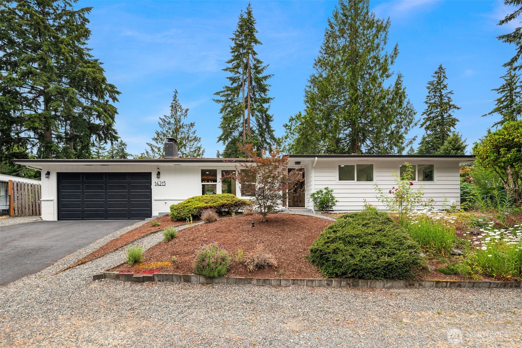Located on a quiet street in Maplewood Heights, this beautifully updated mid-century modern home offers effortless single-level living on a private 10,000 SF lot. Original architectural character blends seamlessly with remodeled kitchen and baths, oak hardwood flooring, abundant natural light, and a strong connection to the outdoors. The skylit kitchen features stainless appliances, modern cabinetry, eating bar, and walk-in pantry. Multiple living spaces include a fireplace with brick surround, expansive great room with wall of windows, flexible office/den, and spacious primary suite with walk-in closet and remodeled bath. Lush landscaping, flowering gardens, winding illuminated pathway, and a private patio create a true backyard retreat. Attached 2-car garage. Convenient access to Bellevue, Seattle, Sea-Tac, Lake Washington, parks, and major employment centers.