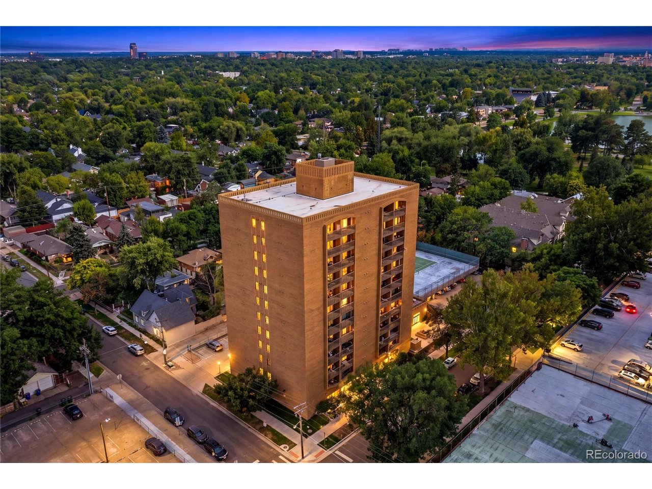 Perched above one of Denver's most beloved neighborhoods, this exceptional 12th-floor penthouse puts you just steps from the shimmering lake and open lawns of Wash Park, with panoramic mountain views as your backdrop! This beautifully updated 2-bedroom, 2-bath condo offers the perfect blend of city convenience and peaceful residential living!  Secure ButterflyMX access welcomes you into the building, where the elevator whisks you to the top floor!  Inside, the lovely kitchen features oak cabinetry, quality appliances and an open pass-through to the dining and living areas, perfect for everyday living and entertaining!  Rich Carlisle wide-plank real pine flooring flows into the inviting living room, where floor-to-ceiling windows fill the space with natural light and frame spectacular mountain views! A custom Hunter Douglas solar shade adds energy efficiency and comfort, while the covered west-facing balcony is the perfect place to relax and take in Colorado sunsets!  Both bedrooms are generously sized, the walk in shower has Jerusalem tile!  The primary suite features a private 3/4 bath and sliding glass doors opening directly to the balcony, while the second bedroom enjoys a full bath just steps away! Both baths offer classic tilework and oversized vanities with abundant counter space and storage!  Building amenities include an indoor lap pool, cedar sauna, community hot tub, tennis courts, covered assigned carport, secured storage, on-site laundry, worry-free unit maintenance, video surveillance and EV charging! The location is truly hard to beat! Walk to Starbucks, Blackbird Public House, Restaurant Olivia and Origins Sports Bar & Grill! Bike to Old South Gaylord or Cherry Creek for shopping and dining! Enjoy Bonnie Brae Ice Cream less than a mile away! Only 1/2 block to Wash Park's beautiful lakes, gardens and walking paths, as well as the Wash Park Rec Center. Steele Elementary School and South High! Easy access to 6th Avenue and I-25! OPEN HOUSE SATURDAY!!