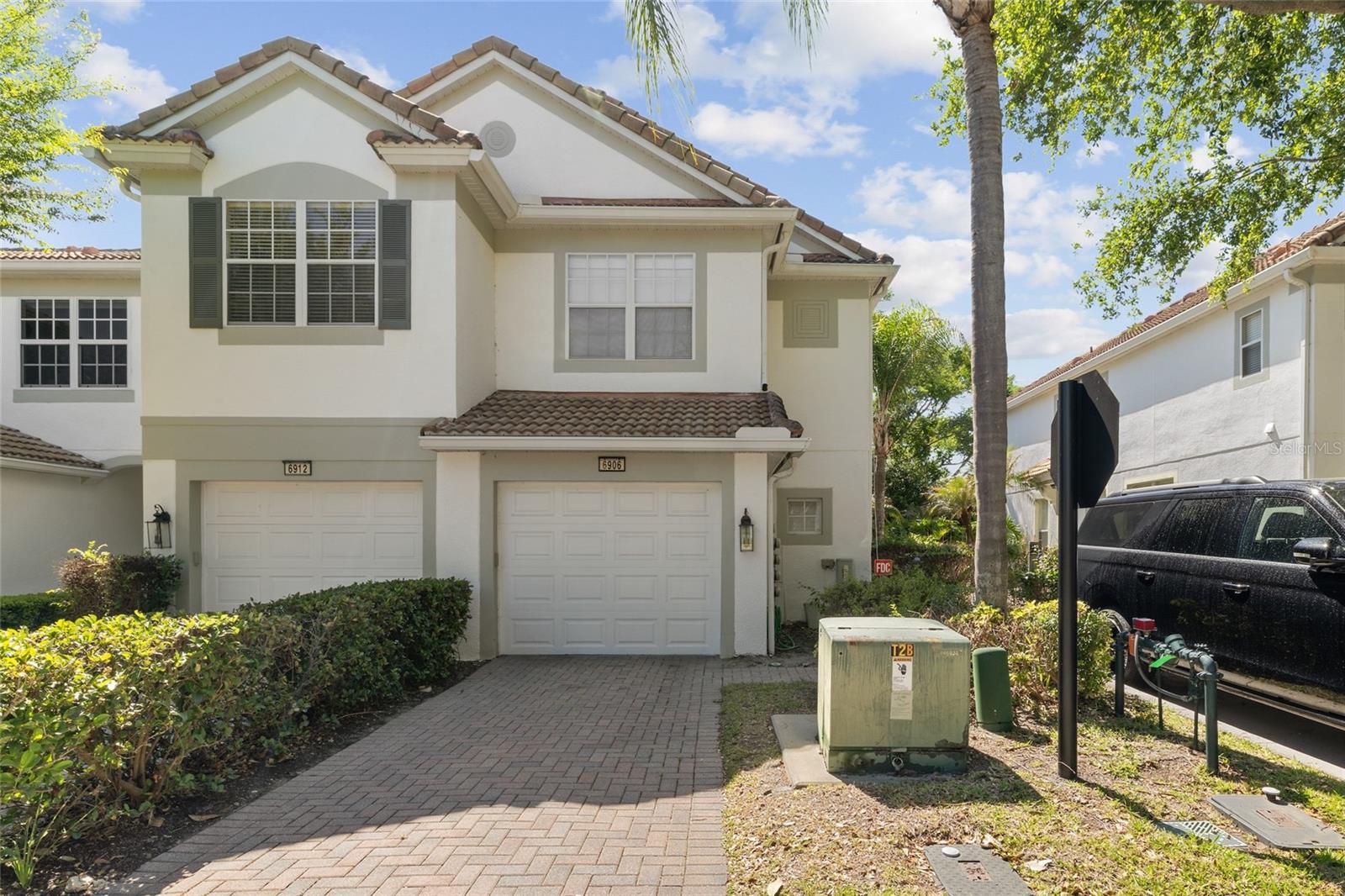 Welcome Home! This beautifully upgraded end-unit San Carlo model offers 3 bedrooms, 2 bathrooms, and 1,656 sq ft of thoughtfully designed living space in the heart of Dr. Phillips. From the moment you walk in, you’ll notice the 9’4” ceilings, all-wood flooring, and abundant natural light enhanced by upgraded triple glass sliding doors leading to a fully enclosed patio. The home features over $18,000 in premium window treatments, including custom shutters in the bathrooms, kitchen, and patio, along with blackout and sheer shades in all bedrooms. California Closets are installed throughout, providing exceptional storage and organization. The kitchen is equipped with upgraded top-of-the-line appliances, and a dedicated laundry area includes a washer and dryer. Upstairs, each bedroom features vaulted ceilings, while the owner’s suite offers dual vanities and a spacious layout designed for comfort. As a desirable corner/end unit, the property benefits from extra natural light, a window in the guest bathroom, and guest parking conveniently located just across. Located in the gated community of The Vistas at Phillips Commons, residents enjoy access to a community pool and cabana, all just minutes from Universal Studios Florida, International Drive, and Bay Hill Golf Club, with easy access to I-4, 528, and the Florida Turnpike. This home offers the perfect combination of upgrades, layout, and location - don’t miss this opportunity, schedule your showing today.