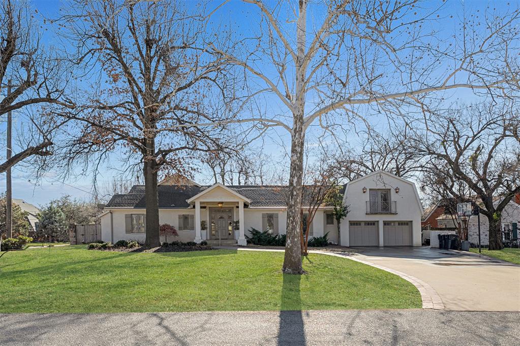 Fantastic home on a large corner lot in Nichols Hills Suburban, offering a gracious and thoughtfully designed floor plan that balances comfort, functionality, and timeless style. From the moment you enter, the home is filled with natural light streaming through expansive windows and a charming glass door, creating an inviting and elegant atmosphere. The home has been tastefully renovated and features beautiful hardwood floors throughout, adding warmth and continuity to the living spaces. Designed with livability in mind, the majority of the home is situated on one level, with the addition of two well-appointed bonus rooms that provide flexibility for a variety of needs. Floor-to-ceiling windows in both the main living area and the primary suite offer serene views and allow the outdoors to blend seamlessly with the interior. The updated kitchen, appointed with Taj Mahal countertops, opens to the spacious family room, which is highlighted by a fireplace and soaring 20-foot cathedral ceiling, creating a welcoming space for both everyday living and entertaining. A wet bar with seating, along with three dining areas, enhances the home’s entertaining appeal. One bonus room, located above the garage and complete with a full bath, is ideal for a game room, home office, or guest suite. The second bonus room offers the perfect space for a playroom or additional flex area. The primary suite serves as a peaceful retreat, featuring its own fireplace and separate his-and-her closets. Outdoor living is equally impressive, with a new covered patio featuring a fireplace, new sliding doors, and outdoor heaters—ideal for year-round enjoyment. This exceptional residence offers generous space, classic comfort, and remarkable versatility in a desirable neighborhood.