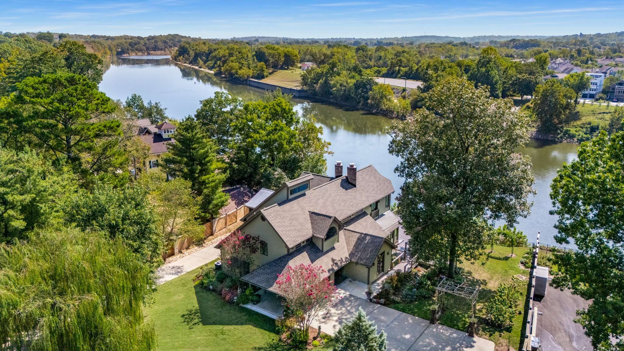 Incredible Gated oasis on the Cumberland River* Spectacular views! Sunlight filled home* Acre lot* Granite kitchen w/stainless appliances~ Kenmore double ovens, KitchenAid dishwasher, New LG 5-eye cooktop~10/2025, & LG refrigerator* Walls of windows* 2 story great room w/see-through fireplace* Peaceful upstairs owner's suite feels like you are living in the clouds* Lux marble bathroom* Remote controlled shades* Panoramic views of the water from the Den* 2 guest suites on the main level* Multi purpose basement with kitchenette (potential home business space)* Indoor grotto* Generously sized vaulted restful screen porch* Wrap around deck* Covered patio* 3 CAR GARAGE*