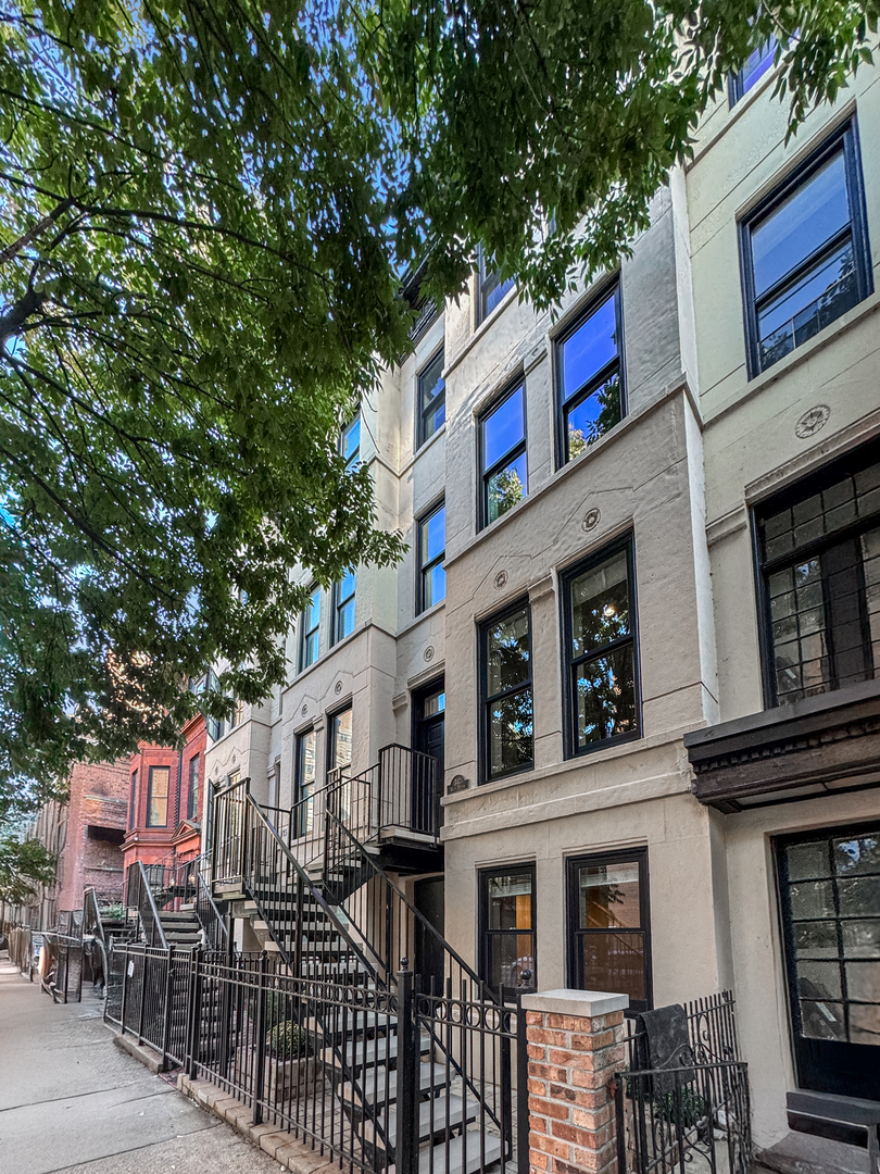 This move-in-ready East Lincoln Park row home is a fabulous alternative to a condo. It offers bright living space with nearly 10 ft ceilings on the main level, hardwood floors, two fireplaces, and updated finishes throughout. The main level features a combo living/dining room, a newer white kitchen, a half bath, and laundry. Upstairs, there are three bedrooms with Elfa closet organizers, two full baths, a family room, and an office or playroom. The garden-level apartment offers flexibility, allowing it to provide income to cover property taxes, serve as an in-law suite or home office, or be incorporated into the main living space by adding an interior staircase. This home has a new synthetic deck off the kitchen, an extra-deep landscaped backyard, and an oversized two-and-a-half-car garage.  The house is ideally located near the park, zoo, nature museum, lakefront recreation, public transportation, and exceptional schools, including Lincoln Elementary.