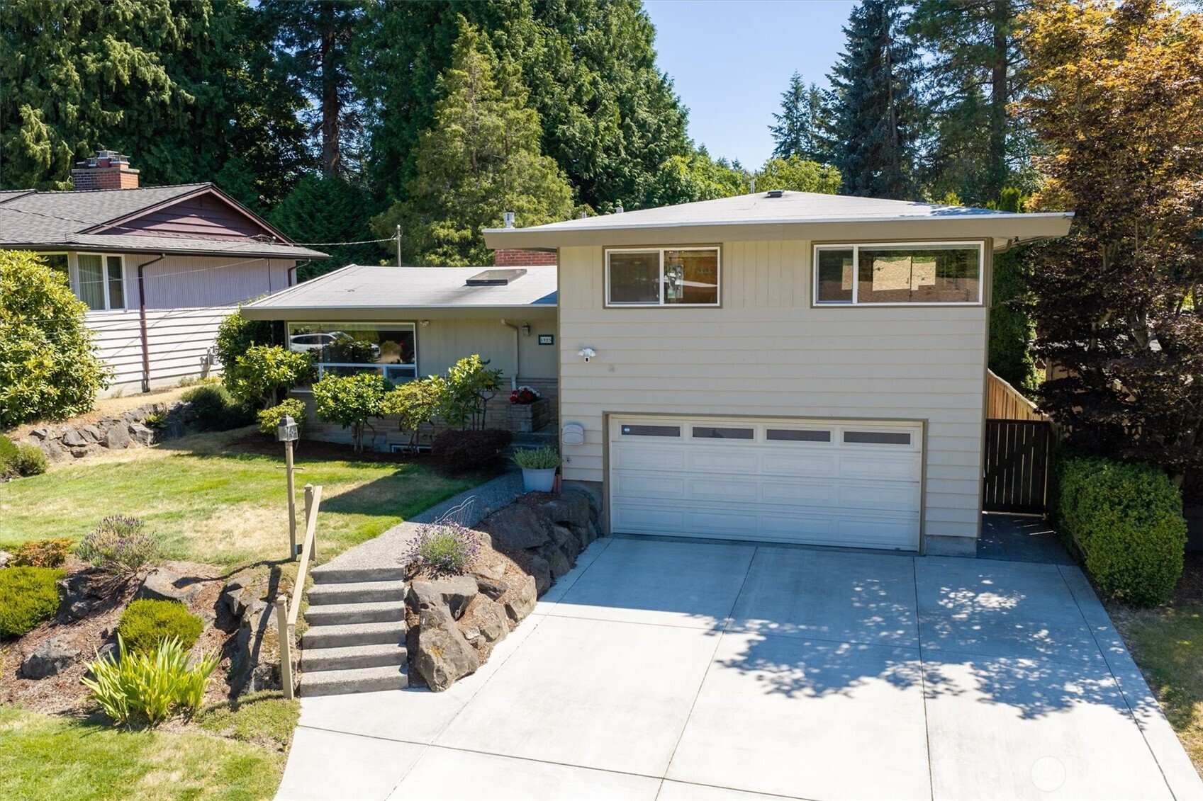 Room for everyone in this lovingly maintained mid-century home, ideally located just ½ block from Gregory Seahurst Swim Club on a quiet residential street. The formal living room w/wood burning insert flows into a light-filled dining/sitting room that opens to spacious decks. The ¾ guest bath also opens to the spacious back deck. The beautifully remodeled kitchen offers abundant cabinetry, generous counter space, and easy access to the dining area for effortless entertaining. The design features a private upper level with a primary suite, complete with a ¾ ensuite bath, plus two additional bedrooms and a full bath. Main and upper level have hardwood floors under new carpet. Just below the main level are a fourth bedroom, a 1/2 bath and a convenient laundry room. The lower level offers a true recreation room with a gas fireplace, fun wet bar, and plenty of space for gatherings, along with an unfinished storage/furnace room.  Step outside to enjoy multiple decks, a large play area perfect for basketball and outdoor activities, a fully fenced backyard, and a spacious two-car garage. A permitted detached 802 sq. ft. annex includes a finished studio with a ¾ bath, currently used as nanny quarters. With only a portion of the building finished, the remaining space offers outstanding potential for an ADU, workshop, studio, or hobby space.  A welcoming home with flexible living spaces and endless possibilities. Downtown Burien has much to offer, easy freeway access in every direction.