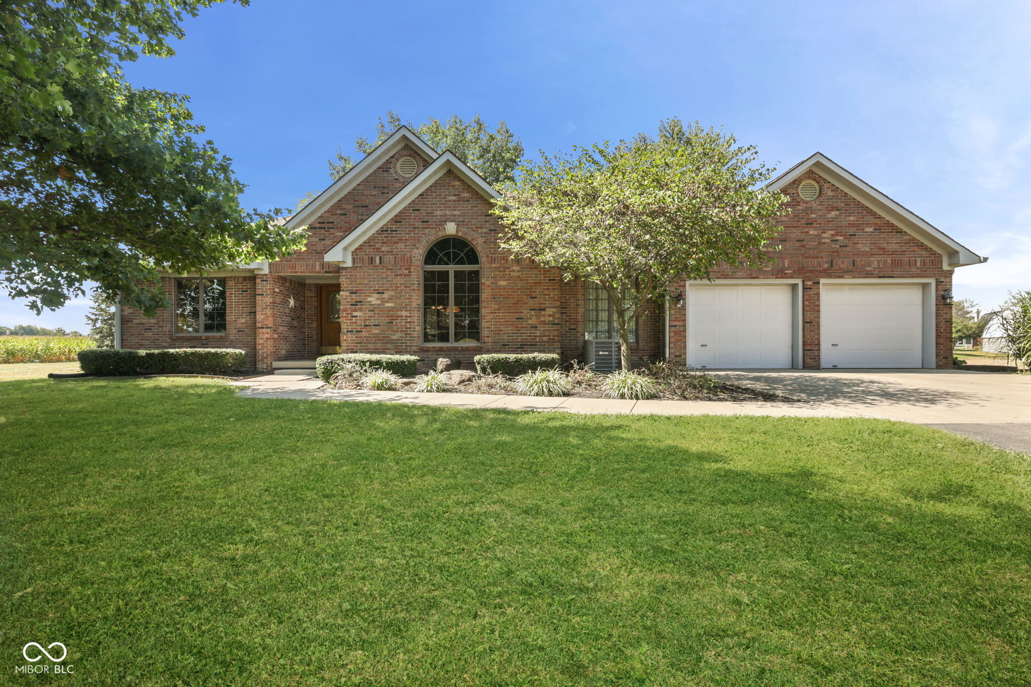 RARE FIND! Custom built, brick ranch with unique features you won't see in any other home! 4bd/2.5 bath, extremely well maintained, residential farm in Johnson County on 10.6 acres (8 acres leased for addtl income potential). Also includes a 40x60 pole barn (w/electricity, concrete floor, workshop, animal stalls area and hayloft/storage), 30x70 hoop barn (2019) with paved floor (last 20ft gravel) and electrical. Park-like setting with a large tractor playset, sand box, hammock, firepit and over 100 deciduous trees. Finished 2 car attached garage with pull down attic for additional storage. Hardwood floors with gorgeous solid wood inlay (signed by artist) and natural woodwork throughout including solid wood doors, cedar plank walls in the family room and indoor cedar porch swing! Remodeled bathrooms with double sinks and natural lighting. Farmhouse style half bath w/custom vanity, pedal powered well pump sink, galvanized basin & potential to add a shower to convert to full bath. Owners suite has a shower/tub & separate garden tub with jets and overhead skylight for soaking away the stresses of the day. The updated kitchen has tons of space with a large breakfast bar, granite countertops, tile backsplash, stainless steel appliances, double oven and gas countertop range making meal prep a pleasure, especially with the HUGE walk-in pantry and easy access to the 36x15 patio w/covered outdoor dining area for entertaining. Outdoor lighting, water access & electrical for RV hookup plus large fenced animal pen/dog run (shed excluded). This expansive property offers a sense of privacy and serenity, allowing you to embrace the tranquility of rural life living while still being close to town. Recent updates: NEW AC, gutter guards, and kitchen french door windows ('25). Water softener ('23 owned), well pump & pressure tank ('21), pantry cabinets and tile flooring ('25/'18).