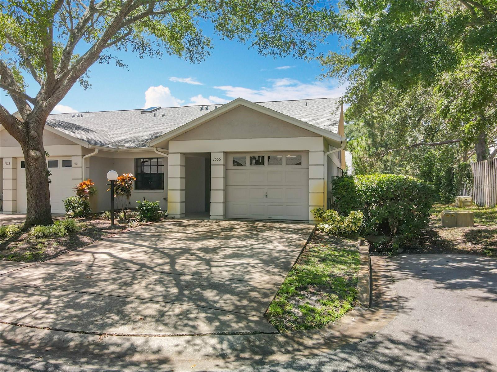 Embrace the Florida lifestyle with this 2-bedroom, 2.5-bathroom, 1-car garage, with bonus loft, end unit villa located in the desirable community of Villas of Forest Park. This spacious Dunedin home has over 1400 sq ft of living space to enjoy. The open-concept living and dining area provides a perfect flow for daily living, and the high ceilings and expansive layout offer ample room for relaxation or fun times with family and friends. The heart of the home is the light and bright kitchen, which boasts stainless/white appliances, a cute bay window for fresh herbs, and white cabinets - perfect for cooking and entertaining. Whether you're preparing a quick meal or hosting friends and family, this kitchen is designed for both style and functionality. The tranquil primary suite invites you to enjoy the serene space with an en suite and spacious walk-in closet. The primary bedroom has high ceilings, a décor ledge, and window to the bonus room expanding the space. The secondary bedroom is spacious with a large built-in closet – a serene space for guests. Upstairs is the loft/potential 3rd bedroom with attached half bath - think home office/hobby room. The bonus room opens to the living area and houses the indoor laundry closet – perfect to use as a den or workout space – with exterior access to the patio and rear green space. Enjoy soaking in the surroundings while enjoying your morning coffee or having an afternoon drink. The attached one-car garage is oversized with additional storage and attic access. NEW HVAC 2025, WH 2023, Roof 2017. Need a little more relaxation? Head over to the community pool, where you can soak up the Florida sunshine, take a refreshing swim, or unwind with neighbors in a tranquil setting – just steps from your front door. Location is everything, and this home has it all. Just minutes from downtown Dunedin and everything it has to offer. Located near Downtown Dunedin, parks, nature trails, Honeymoon and Caladesi Island to enjoy the outdoors. The world-famous Clearwater Beach and two major airports are within a short drive. Close to shopping, restaurants, and entertainment. With so much to explore, you’ll never be far from adventure. Make your appointment to see this unique villa today!