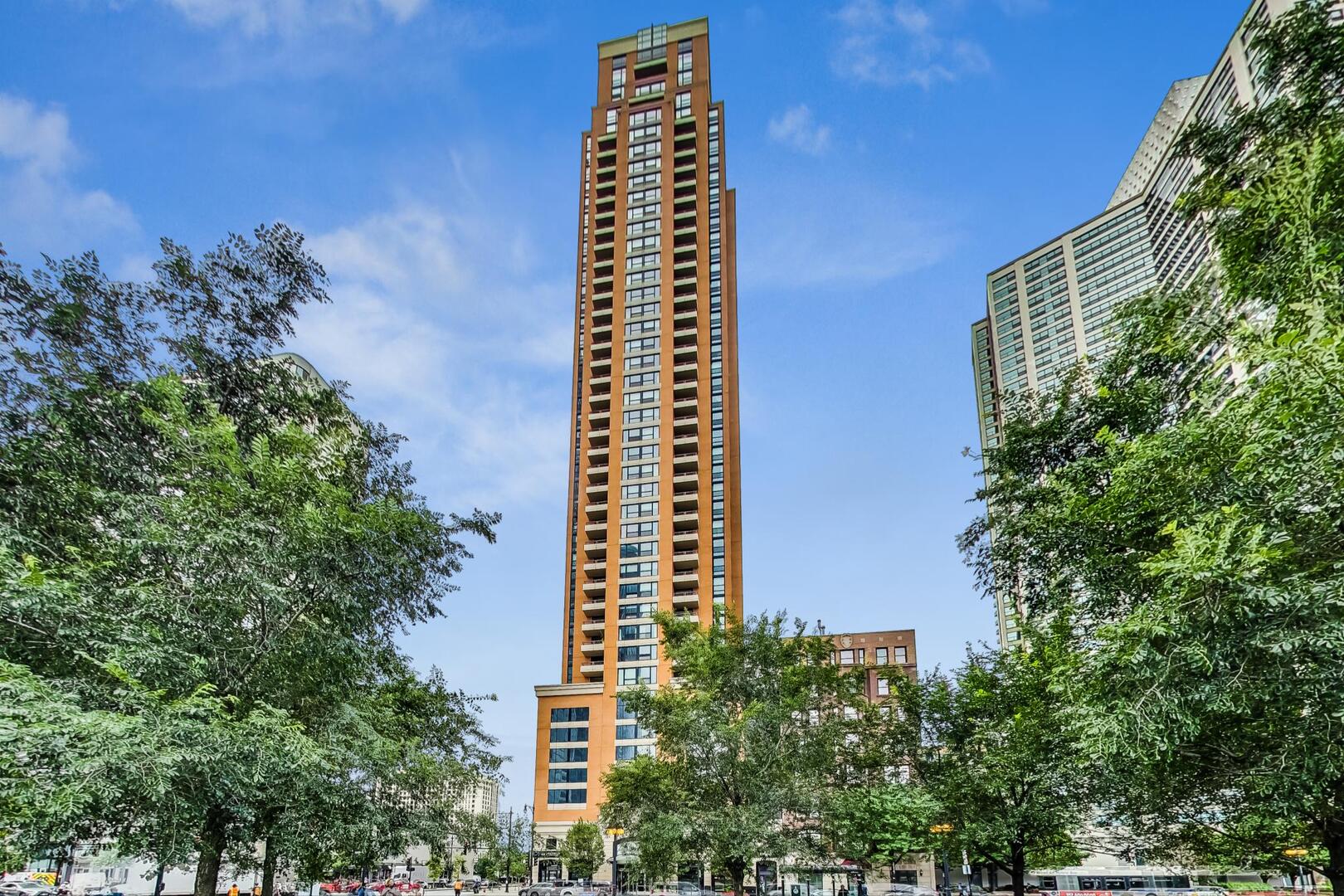 Live the luxe life on vibrant Michigan Avenue with some of the most jaw-dropping views Chicago has to offer from this northeast corner unit! Enjoy sweeping vistas of Grant Park, summer fireworks, the Shedd Aquarium, Field Museum, and Adler Planetarium-all from your private balcony with all-weather tiles. This move-in ready home features an open layout, a chef's kitchen with high-end appliances and finishes, hardwood floors, built-out closets, custom drapery, and in-unit laundry. Originally a 3-bedroom, the home has been thoughtfully converted to a spacious 2-bedroom layout but can easily be reverted.    Located in a full-amenity building with 24-hour door staff, fitness center, and more. Garage parking available for $24,900. Perfectly situated with Trader Joe's at the base of the building, Jewel just one block away, and close proximity to the Red, Green, and Orange lines, Michigan Avenue buses, and major expressways including Lake Shore Drive, I-55, and I-90/94.