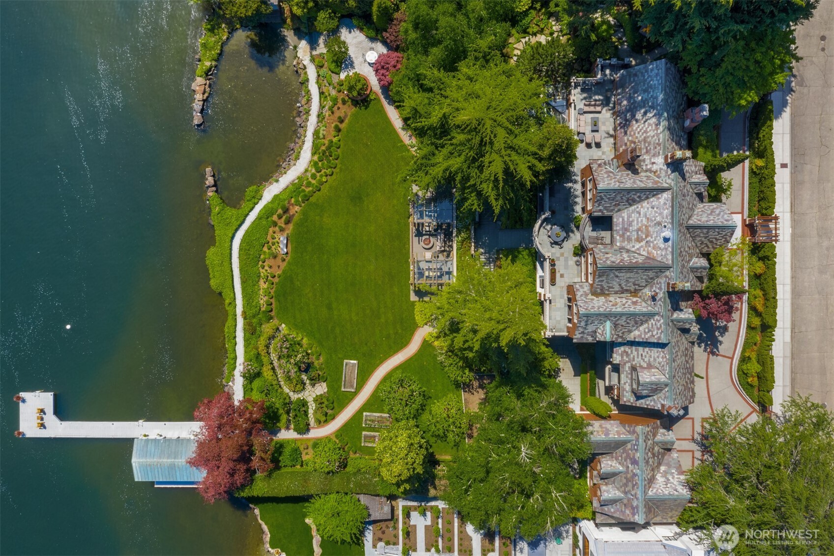 Discover the ultimate private waterfront retreat. With over 200 ft of shoreline on almost an acre, a serene lagoon, private dock, & boathouse, this estate embodies the irreplaceable lakefront playground. Take in sweeping Cascade views, then shift from water to land w/lawn games or evenings by the firepit. Light-filled interiors & expansive living spaces blend effortlessly w/the outdoors, creating an inviting flow for relaxing or entertaining. The indoor pool, gym, gardens & rec room were designed for endless fun. Whether hosting or savoring quiet moments, this beautifully renovated home offers iconic Seattle style w/modern living. A truly special opportunity in Laurelhurst, w/ideal access to shopping, dining, downtown Seattle, &  Bellevue.