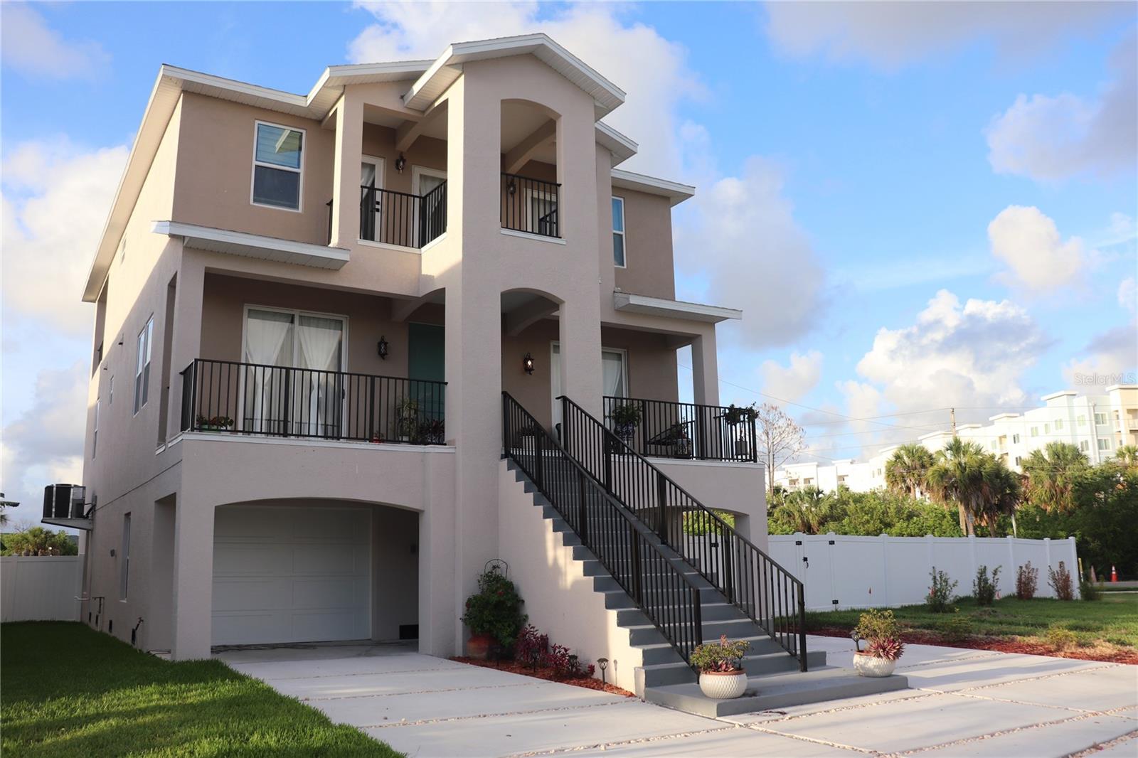 Nestled just minutes from our Community private beach, and Club House with pool, tennis courts and access by boat to the Gulf of America!  Step into modern coastal elegance with this brand-new 2025 house in Sea Colony.  The heart of the home is an expansive, light-filled open-concept kitchen and dining area featuring a massive island with luxurious granite countertops in rich earth tones, premium gold-finished faucet, wood cabinetry, stainless steel appliances, including a range and hood.  The space flows effortlessly to a charming dining nook with light color curtains that bathe the room in natural light from the balcony.  Newly built, completed in December 2025. The home boasts a modern and elegant style with clean lines, high ceilings, and an open-concept design that seamlessly integrates a spacious living area, dining room, and gourmet kitchen. Enjoy nature views through the impact glass doors that connect to the balcony. The third floor includes an oversize master suite with a oversized walk-in closet and a luxurious en-suite bathroom with double vanities, and an extra room which it can be used as an office space, a playroom or anything you want. The view from the third floor is spectacular!  The sunsets or the sunrise will make your day more pleasant!  The second bedroom and the third one are in the second floor, each one has their own full spacious bathroom, both bedrooms have share the same balcony.  Expansive 4-car garage, plenty room for vehicles, toys, golf cart or extra storage. Plus, the green area, already fenced, is a perfect paradise for you and your family. Don't miss this rare opportunity to own a brand-new house 3 story in one of the most desirable areas in New Port Richey, schedule your private tour today!