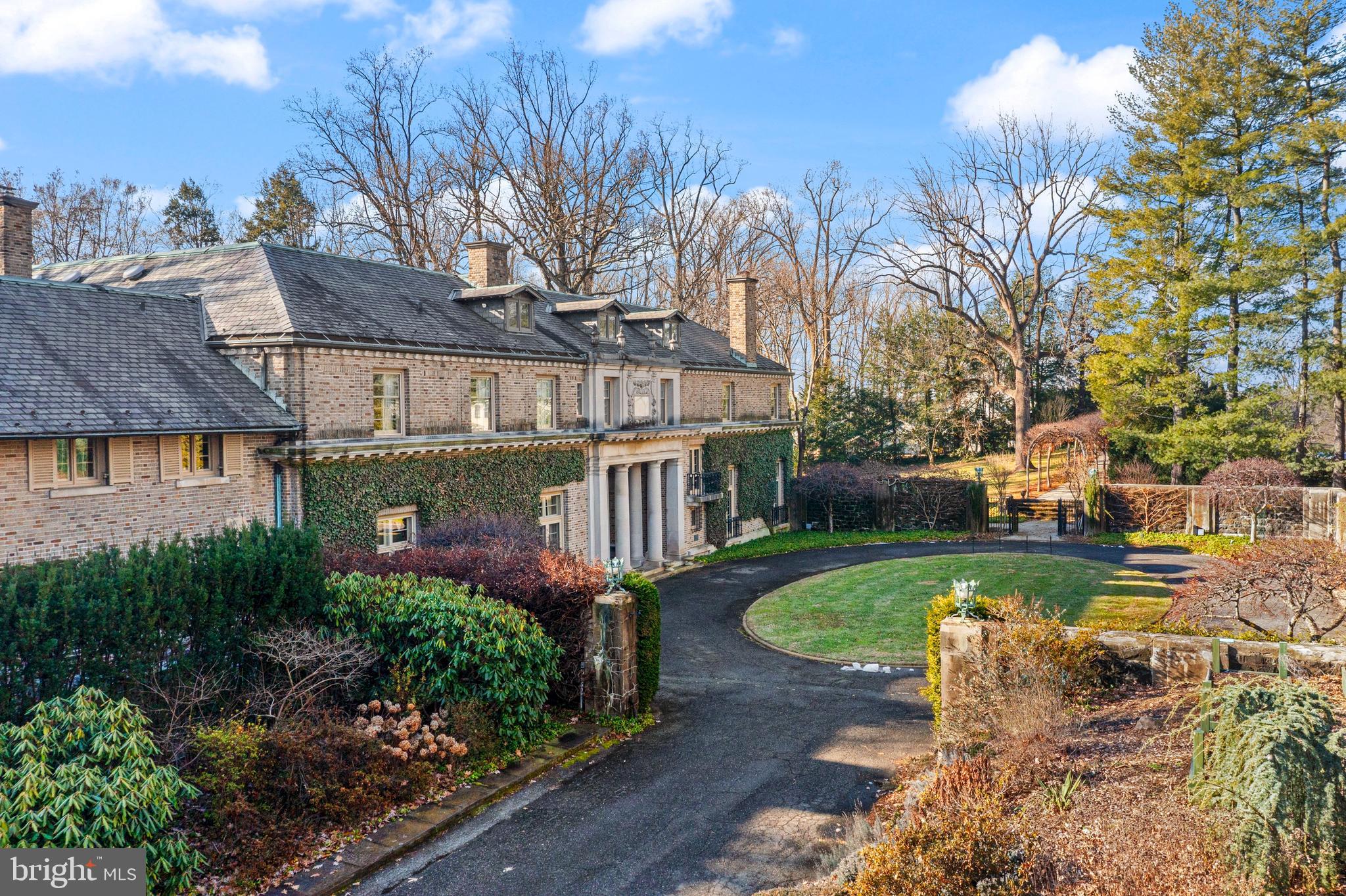 One of the last great estates of the Main Line, Camp Woods is a distinguished Italianate-style Villanova home on 3.4 beautifully landscaped private acres, offering a rare combination of historic architectural integrity and private recreational amenities, including a regulation-size hardball squash court. The ¼-mile drive, which is next to the Ardrossan Estate, leads into a walled courtyard with a circular drive.One enters through a limestone porch with Doric columns into the transverse, covered, ceilinged hallway with French doors leading to the terrace, reflecting pool, and two loggias. Full of light, the main floor flows into the grand living room, the library, the morning room, and the dining room. All rooms have French doors and beamed or decoratively plastered ceilings. With fireplaces in each room and rich architectural detail, this is a house made for entertaining.The kitchen is functional yet true to the home’s character, featuring custom wood cabinetry, hand-painted tile, a central island, and a high-quality range. The wood-paneled large butler’s pantry supports both everyday living and entertaining.The bright studio/office offers a separate entrance and access to the terrace.Upstairs, the home is anchored by a dramatic gallery-style hallway with soaring barrel-vaulted ceilings and abundant natural light. At each end of the upper level, two expansive primary bedroom suites create private retreats, each with its own fireplace, sitting or lounge area, bathrooms, dressing areas, and views over the gardens. There are two other large bedrooms with interior bathrooms in the main hall. Two additional bedrooms have bathrooms across the hall. There is also a second-floor laundry.Additional features include nine fireplaces in total, one gas and eight woodburning, a wine cellar, regulation-size hardball squash court, playroom, workshop, and mushroom cellar.The property has stunning mature trees, raised garden beds, garden paths, and stone walls.The residence is in an excellent state of preservation. With the exception of certain service and utility areas, the home retains its original architectural integrity. Camp Woods is an exceptional home on a well-landscaped private property in the highly sought-after Radnor School District.