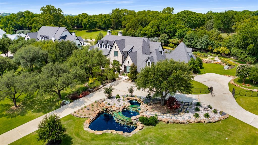 Welcome to 1370 Red Oak Trail, a remarkable single-family home built by renowned builder Ron McHam Homes nestled in the serene community of Fairview, TX. This expansive and private residence boasts 6,009 square feet of elegantly designed living space, offering an exceptional blend of comfort and luxury.The home features five spacious bedrooms and seven well-appointed bathrooms, ensuring ample privacy and convenience for family and guests alike. With hardwood floors, the interior exudes warmth and sophistication, complemented by a working fireplace that adds a cozy touch to the living area. For those who enjoy outdoor living, this property is a paradise and feels as though you are at a luxury Four Seasons golf resort. The meticulously landscaped grounds include a stunning below ground pool, a heated pool, and a relaxing hot tub, making it perfect for entertaining or unwinding after a long day. The inviting patio and porch areas provide additional spaces for leisure and enjoyment with over $700K in plush landscape and hardscape along with 3 pitching stations for the golf enthusiast to work on short game! Inside, the home is equipped with central air conditioning and heating, as well as gas heat, ensuring year-round comfort. The attached 4-car garage offers secure and convenient parking for the car enthusiast. Enhanced by a state-of-the-art security system and electric gate for peace of mind comes standard. This exquisite home at 1370 Red Oak Trail perfectly combines luxury and practicality, offering an unparalleled lifestyle for its new owners. Don't miss the opportunity to make this exceptional property your own. Contact us today for a private showing!