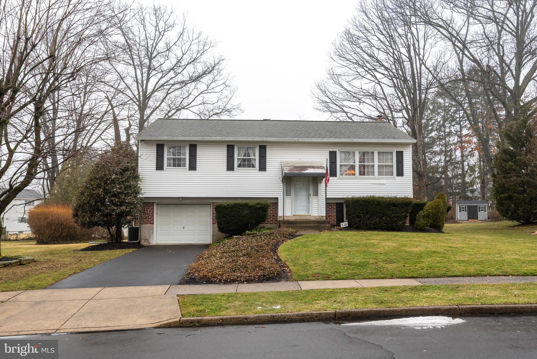 Tucked into the quiet Storybook neighborhood of Warminster sits 538 Parmentier Road. A beautiful bi-level home with three bedrooms and two and a half baths just minutes from multiple parks, shopping, commuter routes,  and walkable to the local elementary school!  Upon entry you will notice the  large foyer bathed in natural light with stairs that lead to the upper level of the home.  The upper level is where you will find the kitchen with a casual dining nook,  and a secondary staircase for quick access to the family room downstairs. From the kitchen you are connected to the formal dining room that has oversized windows and enough room for a large dining table, credenza and china closet. The dining room is open to the living room with more windows adding to the natural light abundant in the upper level. From the living room you walk down a hallway with ample storage space and a full  bathroom. At the end of the hallway you will find the primary bedroom with en suite full bathroom with walk in shower, as well as, two additional large bedrooms.  The lower level boasts a grand family room with wood burning fireplace, built in cabinetry, half bath, access to garage as well as to the backyard and patio. The back yard and patio are oversized with a nice mix of sun and shade throughout the day the level yard provides lots of room to entertain while offering a sense of privacy.  The garage is oversized and has additional space for storage or a potential room. This home has been lovingly maintained by the original owners and is ready for it's next family to make their own and add their personal touch.