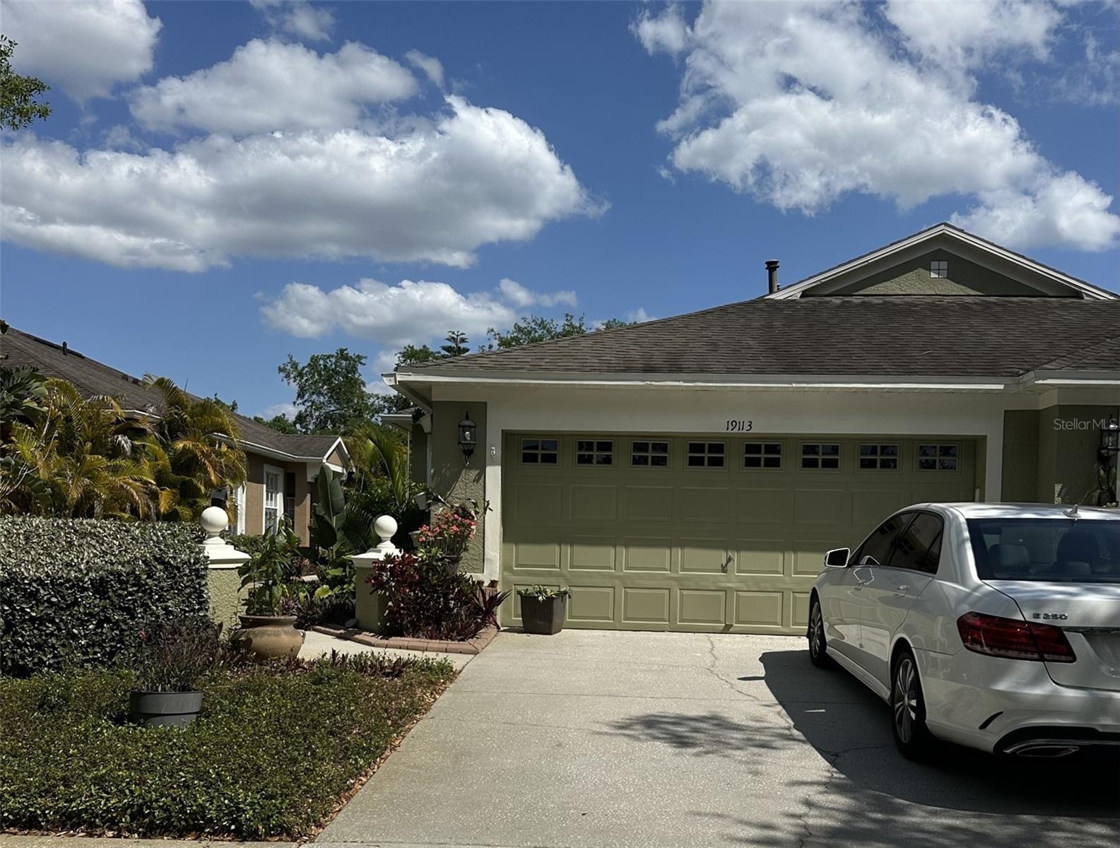New Tampa villa in gated community on water view conservation lot. features real 3 bedroom with windows and closets,2 baths and 2 car garage, 1829 sq. ft. Kitchen features wood cabinets, granite countertops, upgraded breakfast area with windows for lots of natural light. Great room is 27x14, windows and sliding glass provide great conservation views. Floors are wood laminate in the main areas (no carpet ). Master is 25x12, extended for sitting, exercise or office area, custom walk-in and linen closet built-ins, added wall storage by California Closets. Den with french doors, second bed and bath are at the other end of the villa. Both bathrooms have been updated. Extended screened lanai overlooks conservation area. Community: Doves Landing has a village pool. West Meadows has a community center with recreational building, tennis courts, playground, and pool with water slide. Clark Elementary is across the street from the village entrance. Close to shopping, movie theater, USF and several hospitals.