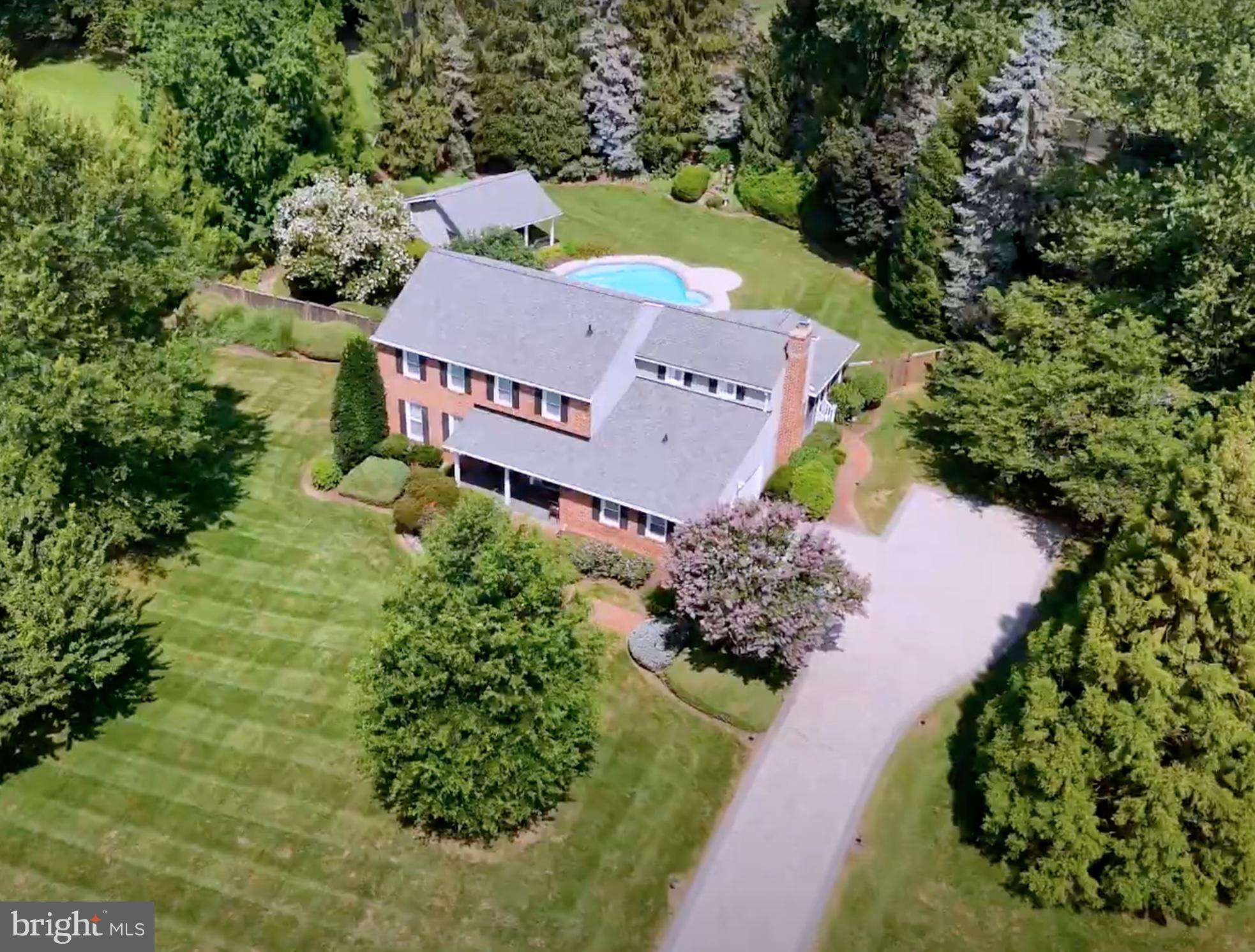 Elegant brick-front colonial home set on over two private acres in sought-after Equestrian Park. Tucked away on a quiet cul-de-sac, this exceptional residence offers rare privacy, resort-style outdoor living, and refined interior spaces just minutes from Metro, major commuter routes, and Dulles Airport.A picturesque stone driveway leads to the home, where manicured grounds unfold into an extraordinary outdoor setting. The expansive fenced backyard is designed for both relaxation and entertaining, featuring a heated in-ground pool, a cabana/pool house, and a large, screened porch overlooking the grounds. Beyond the main yard lies a separate recreation area with private tennis and pickleball courts, tennis house with viewing porch, and an open lawn, creating a truly unique estate-like retreat.Inside, timeless architectural details and quality finishes define the home, including hardwood floors, crown moldings, plantation shutters, and Roman shades throughout. The gourmet kitchen is thoughtfully designed for both everyday living and entertaining, anchored by a large granite island with seating and appointed with stainless steel appliances, including a Professional Service Thermador Triple Oven with warming drawer, standard oven, and microwave, a Thermador six-burner cooktop with pot filler, Zephyr chef’s hood, wine refrigerator, slate backsplash, and under-cabinet lighting. A formal dining room sits just off the kitchen for elegant gatherings. The family room with raised brick hearth fireplace opens through French doors to the screened porch, seamlessly connecting indoor and outdoor living. Additional main level spaces include a formal living room and generous family gathering areas. The luxurious primary suite offers a private sitting room and a beautifully renovated spa bath featuring floor-to-ceiling tile, double vanity, walk-in shower, and custom walk-in closet with built-ins. The finished lower level provides exceptional flexibility with a large recreation room, separate den/workroom, and a third full bath, ideal for entertaining, guests, or home office use.The home also features Lutron smart lighting, double-pane storm windows, and Schlage electonic locks on doors with remote monitoring. Extensive system upgrades include new HVAC (2024) with steam humidifier, Air Knight air purification system, and remote Carrier system management app, 105 gallon Rheem Marathon hot water heater, and new roof (under 2 years). Propane tank for the pool heater is under 2 years old. Remote programmable management capability for in-ground Rainbird Sprinkler system. Verizon FIOS and Cox Internet are available.  A rare opportunity to own a private luxury retreat on over two acres in one of Fairfax County’s most desirable communities.